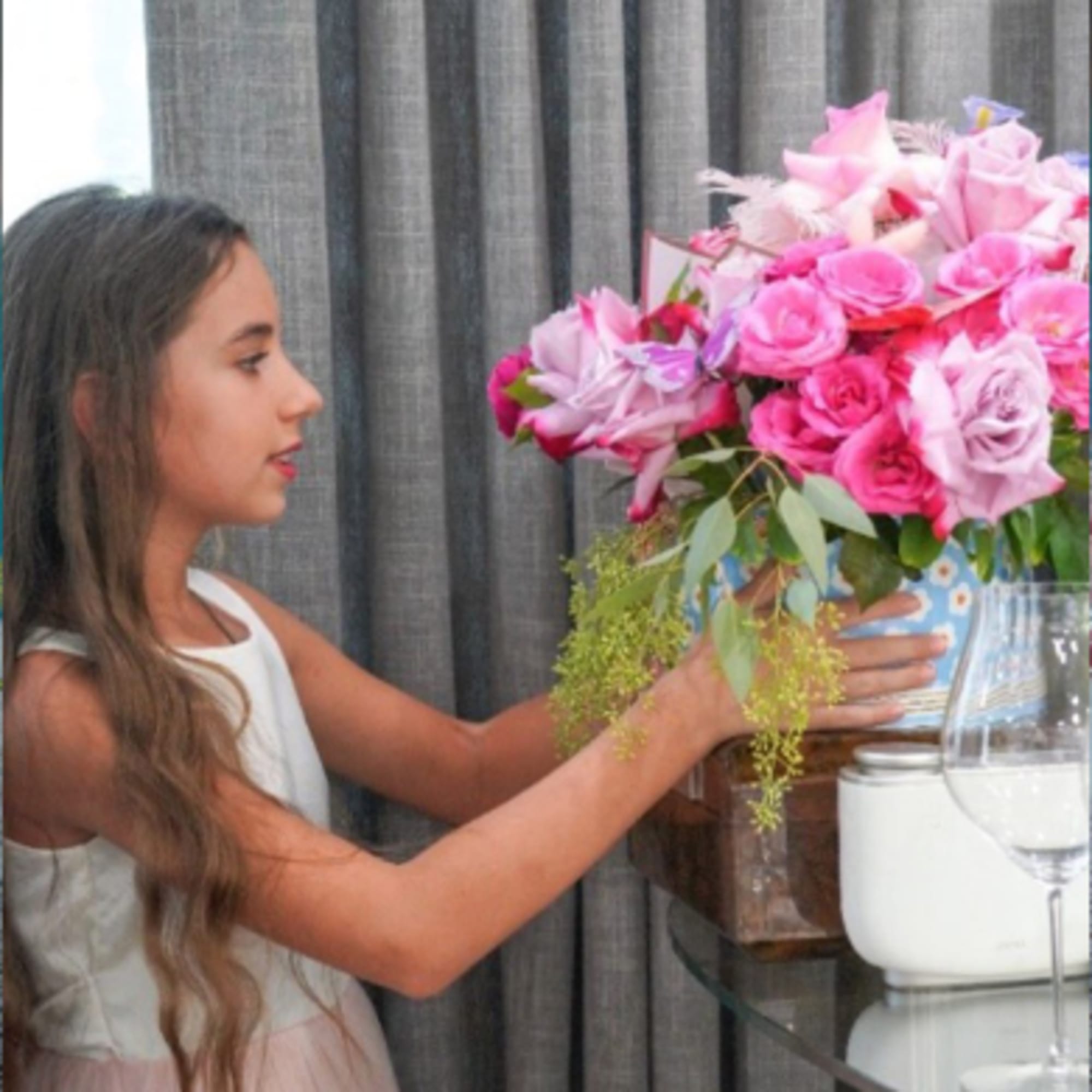 Girl holding a large pink rose bouquet in a box