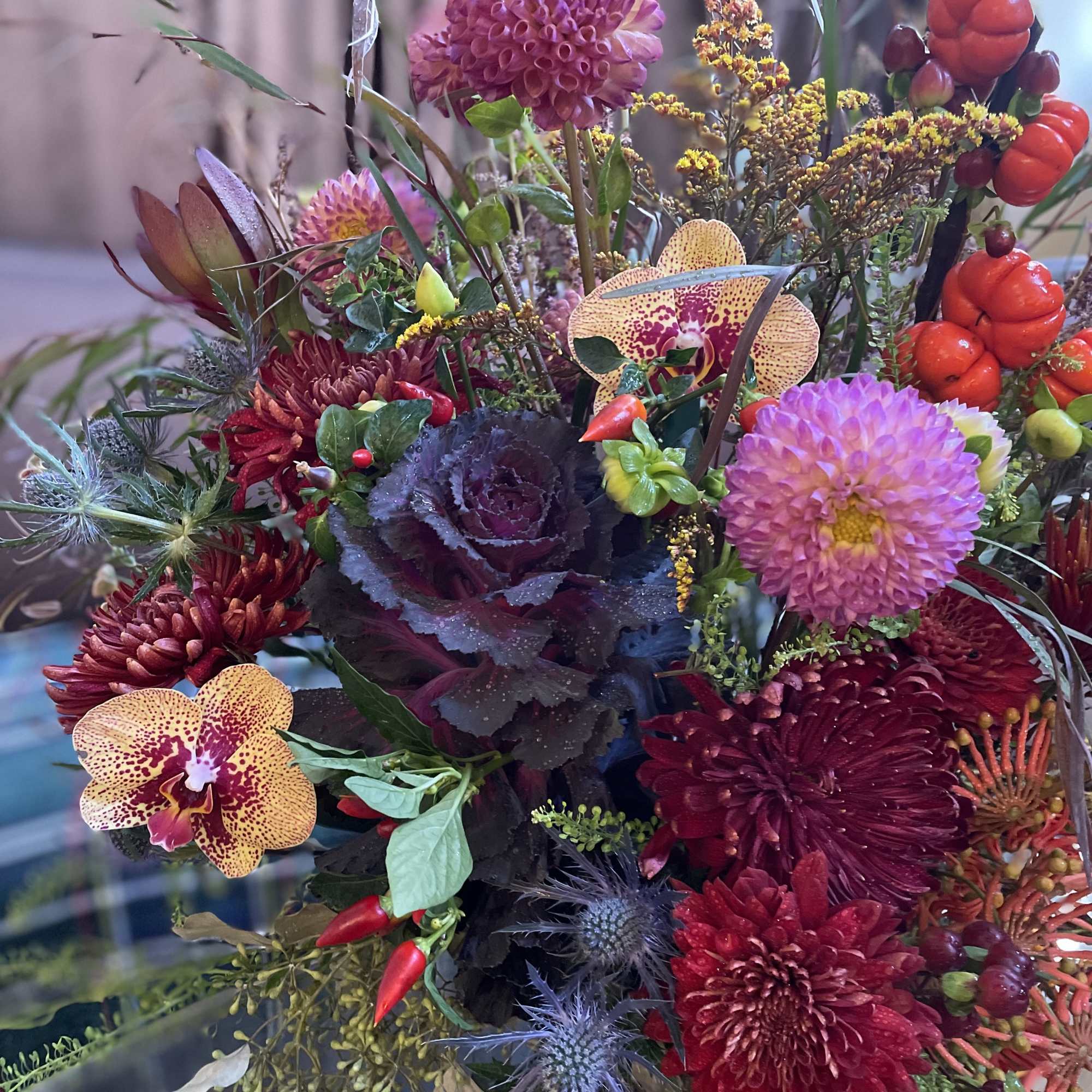 Mixed bouquet with burgundy dahlias and spotted orchids