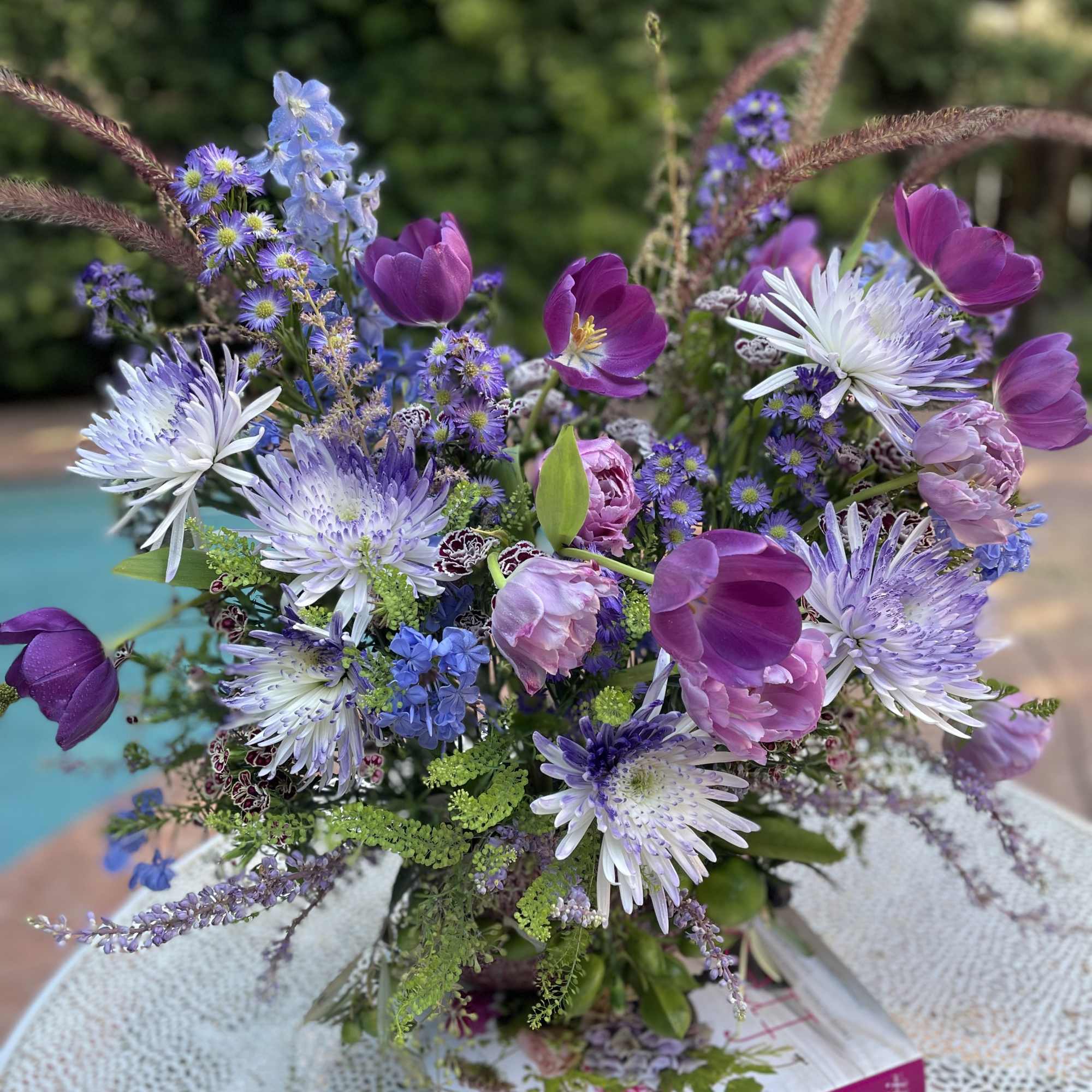 Purple and pink mixed bouquet with white spiky blooms