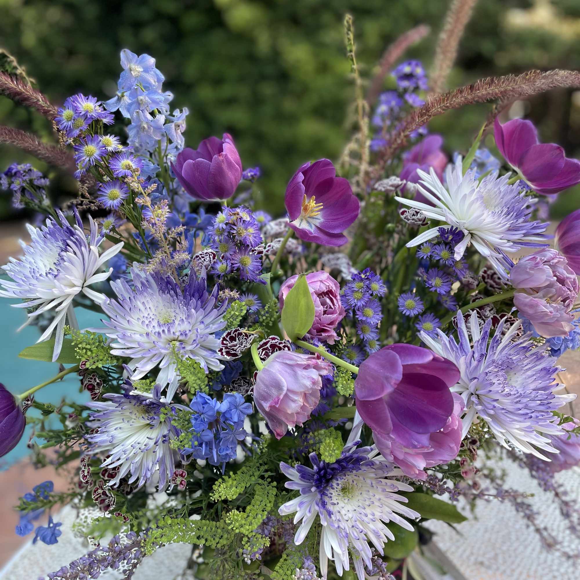 Mixed bouquet of purple and blue flowers with white blooms