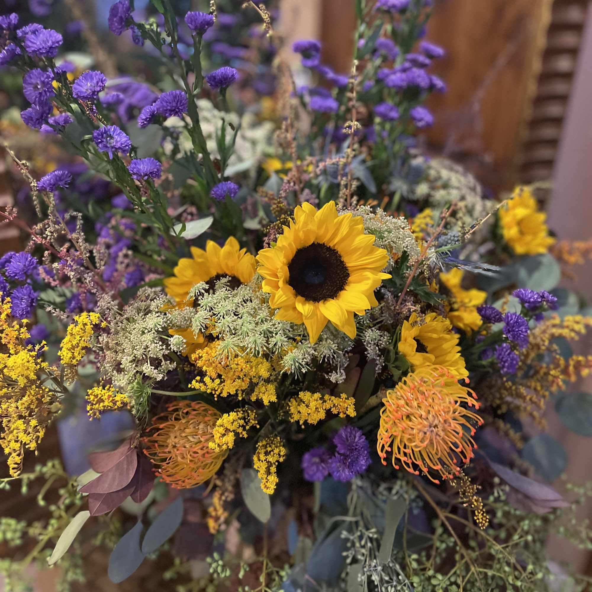 Bouquet with sunflowers, purple blooms, and yellow filler flowers