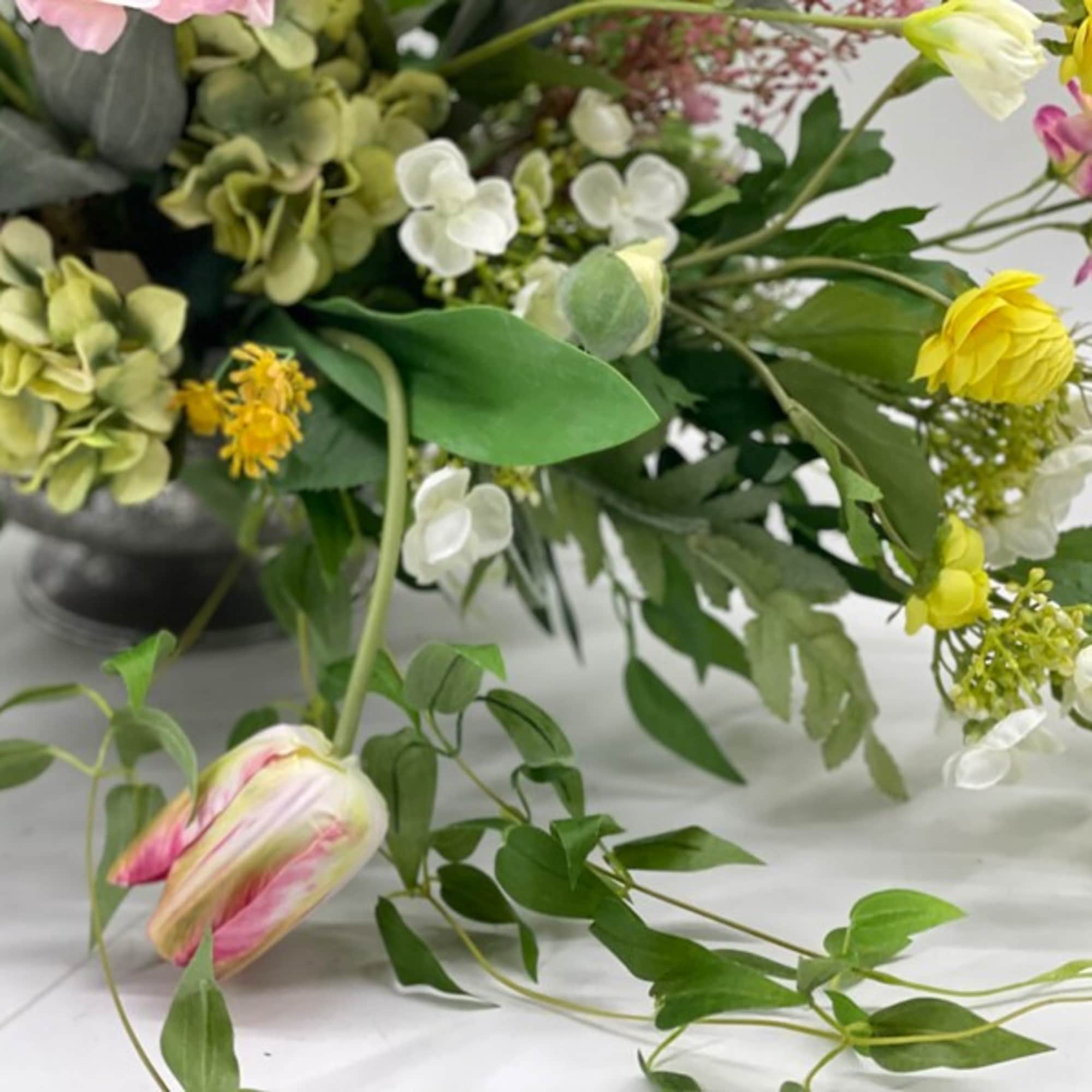 Mixed bouquet with pink, yellow, and white flowers on a table