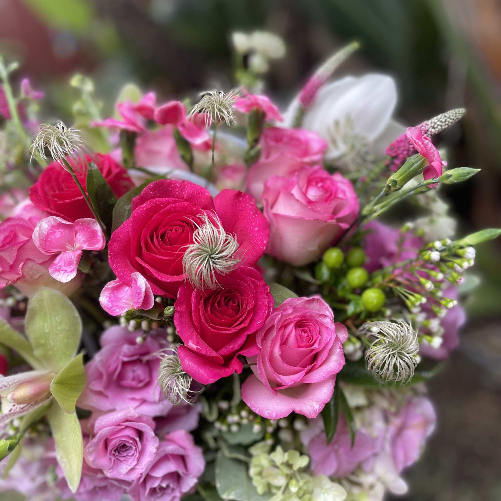 Pink and magenta rose bouquet with small accent flowers