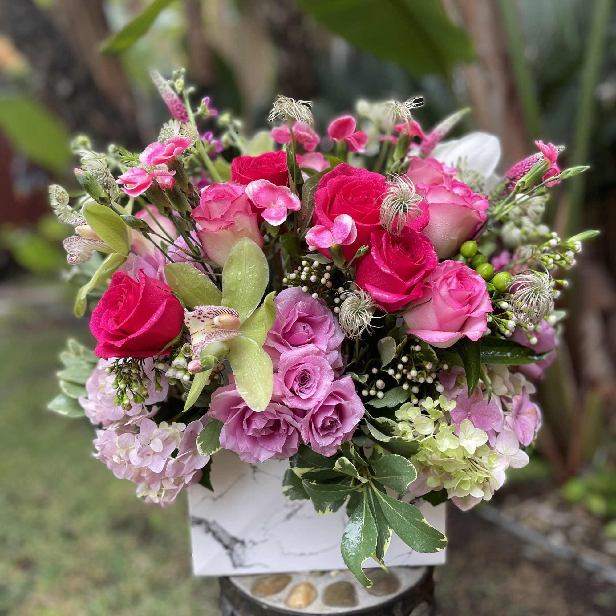 Pink and lavender rose bouquet in a white box