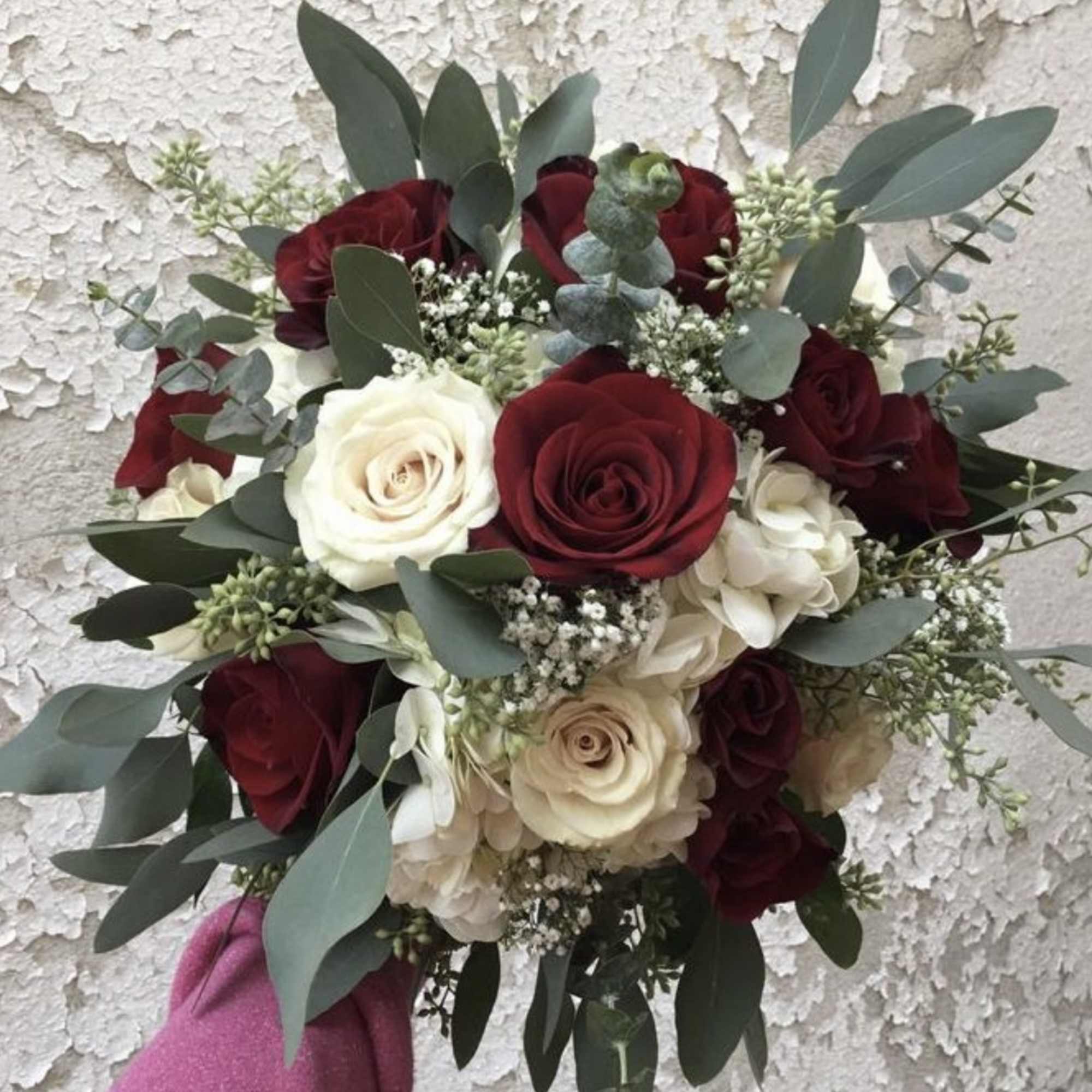 Bouquet of red and white roses with eucalyptus greenery