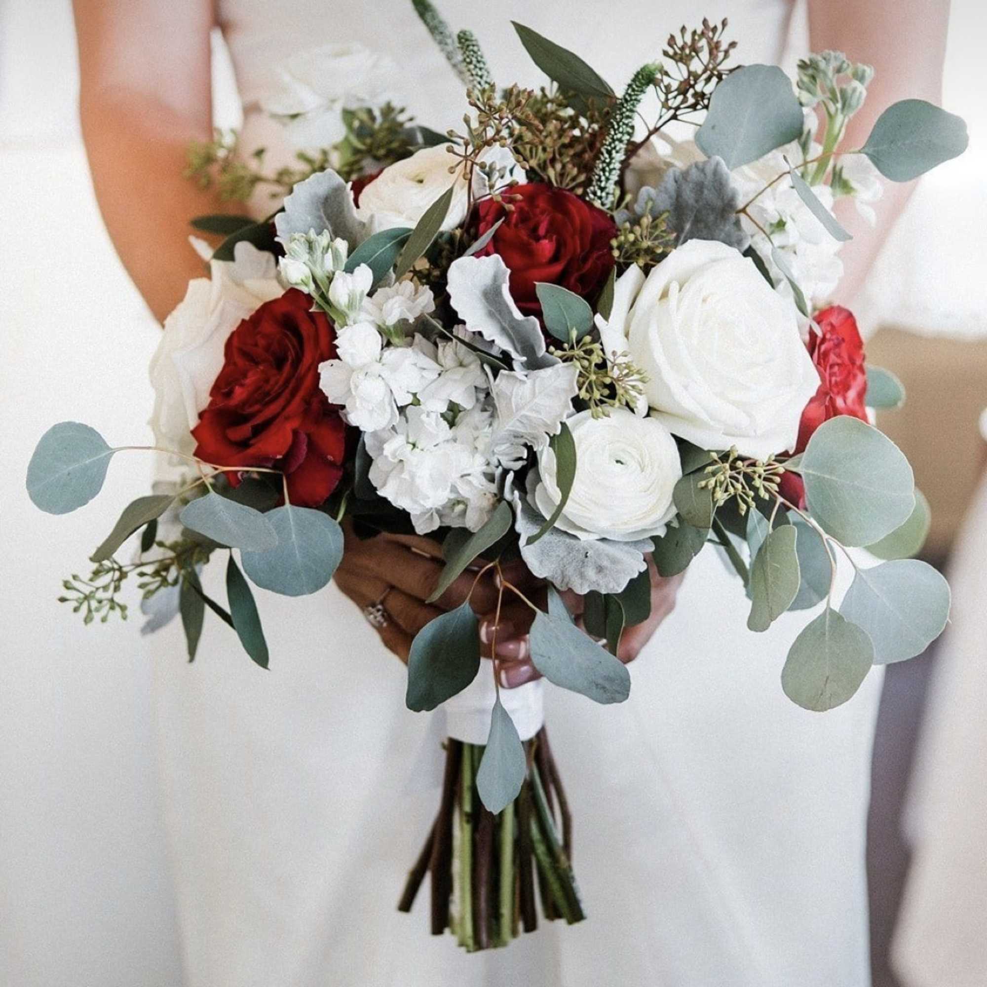 Bridal bouquet of red and white roses with eucalyptus