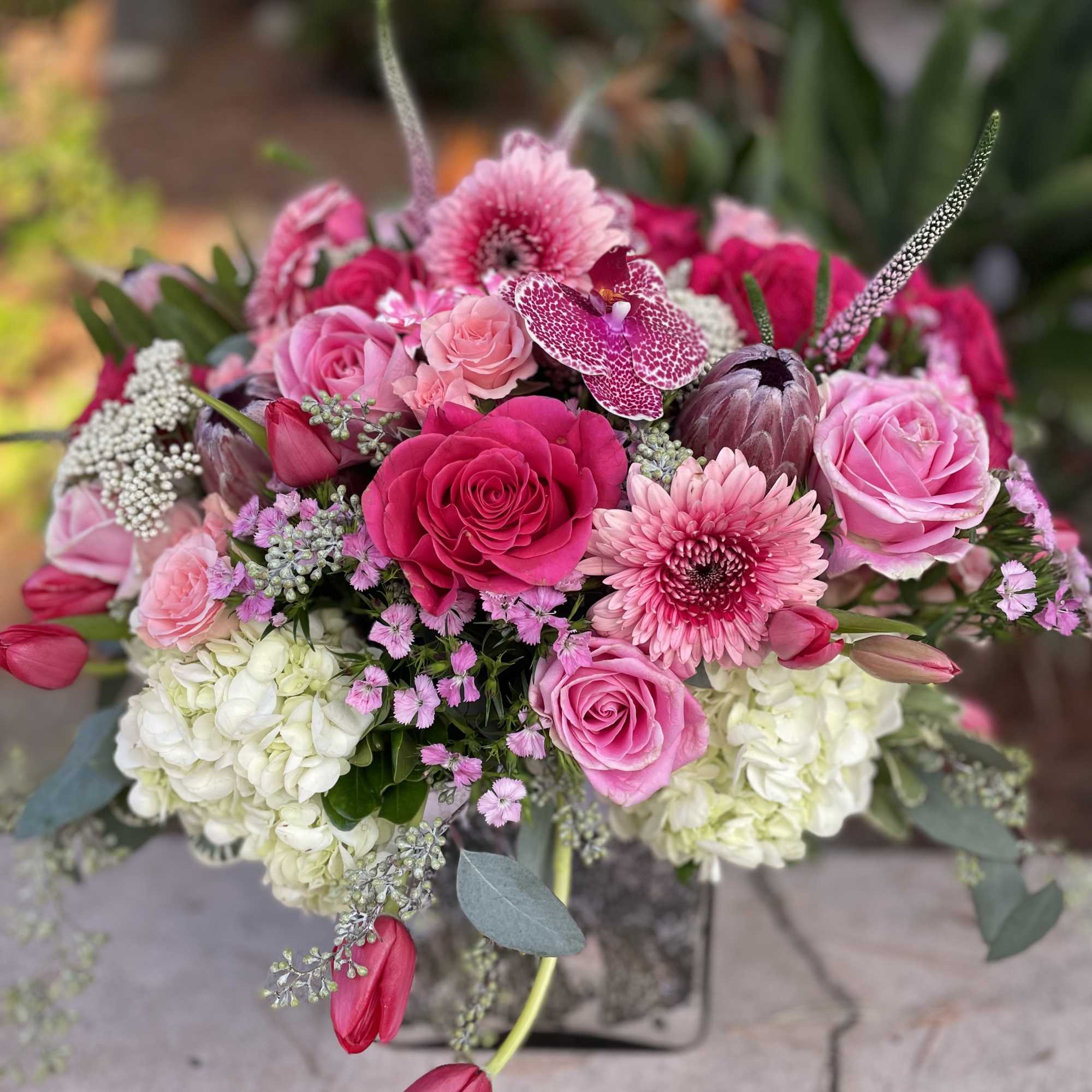 Pink and white bouquet with roses, orchids, and chrysanthemums