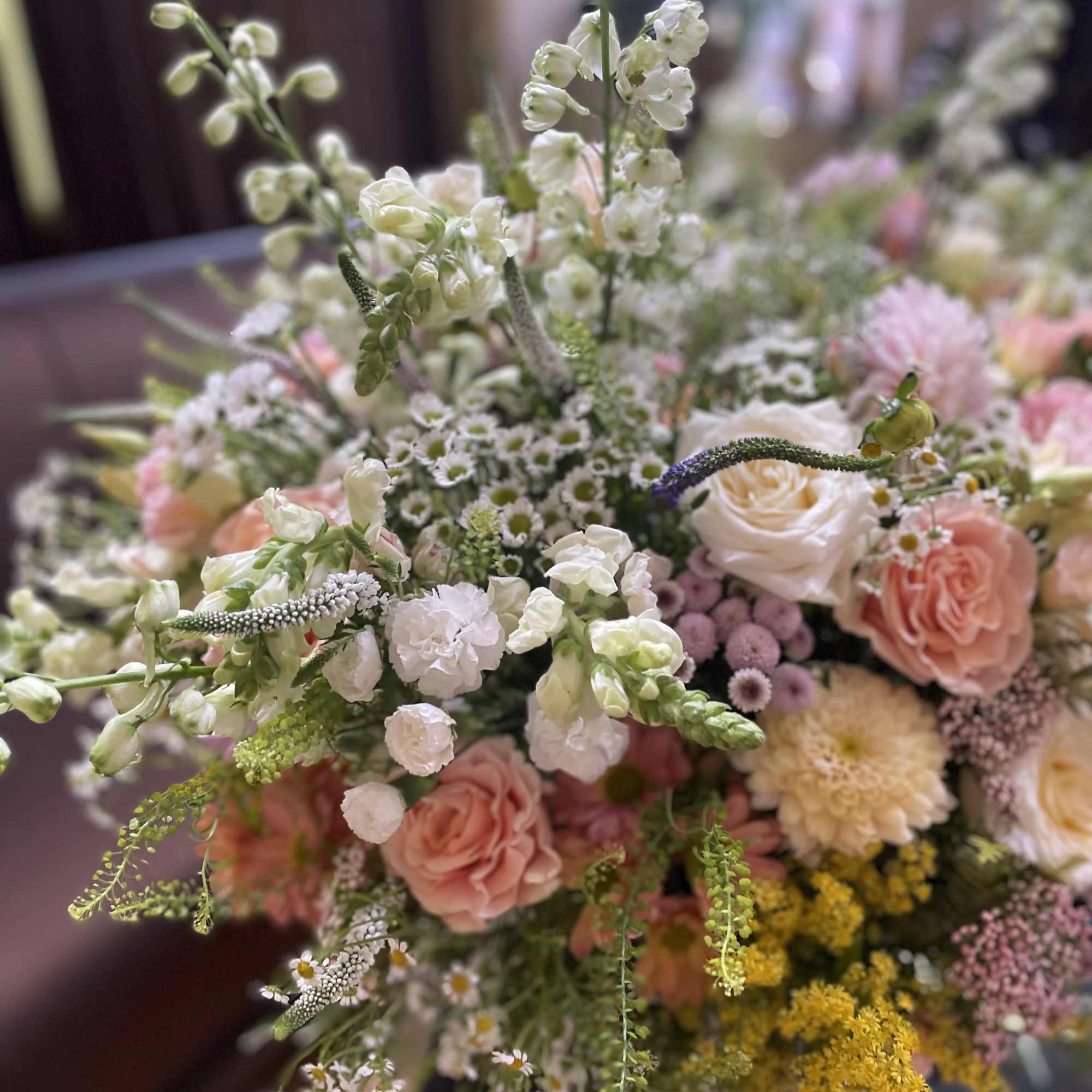 Large bouquet of pastel flowers with white spikes and pink roses
