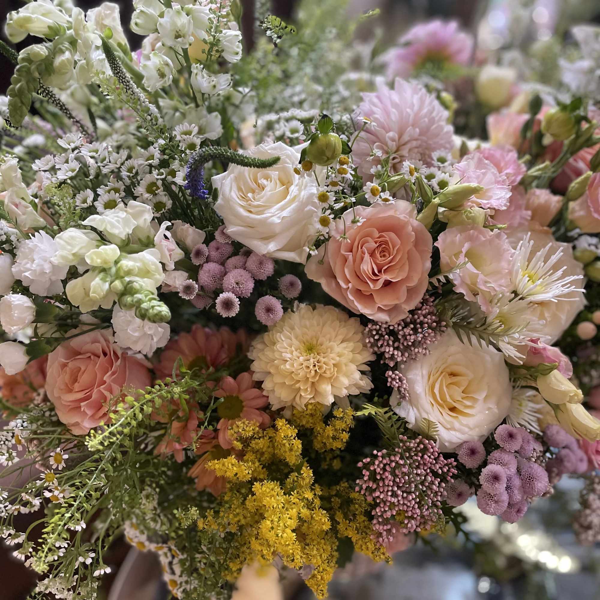 Pastel bouquet with roses, chrysanthemums, and small white blooms