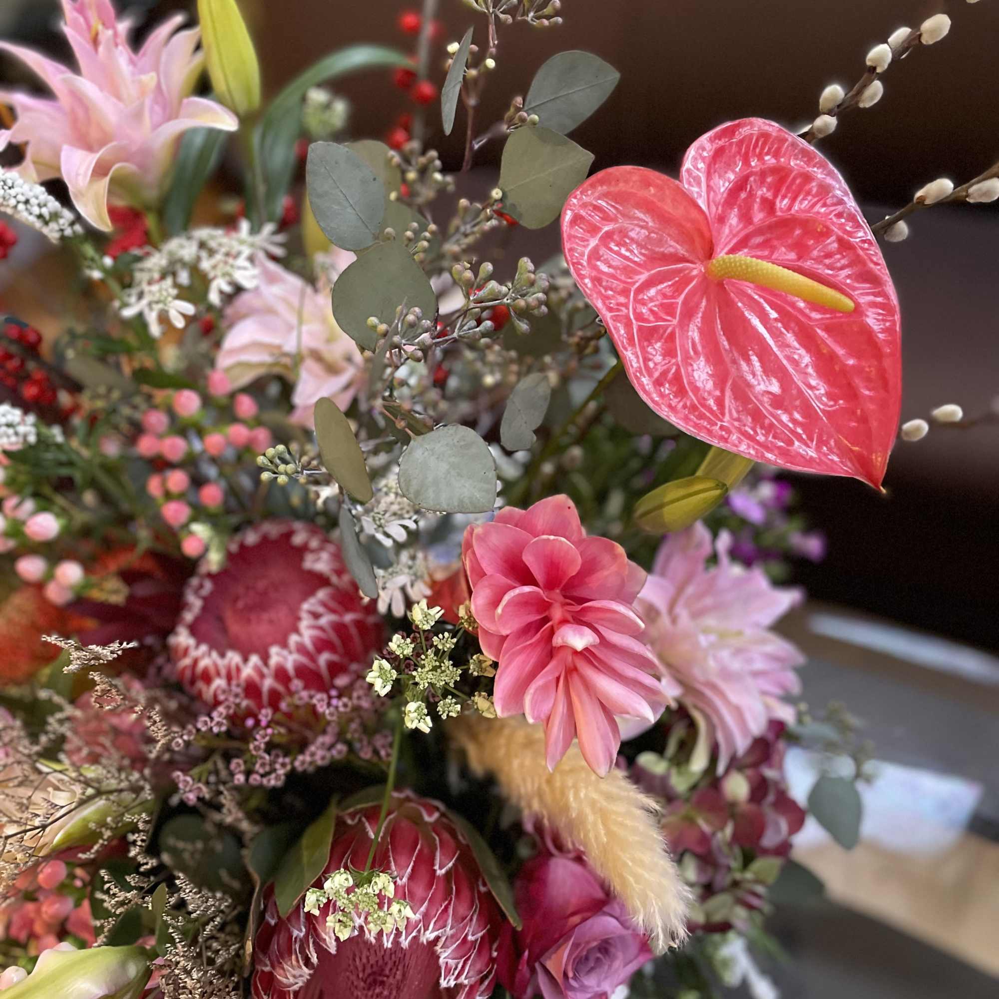 Pink and red mixed bouquet with lilies, protea, and anthurium