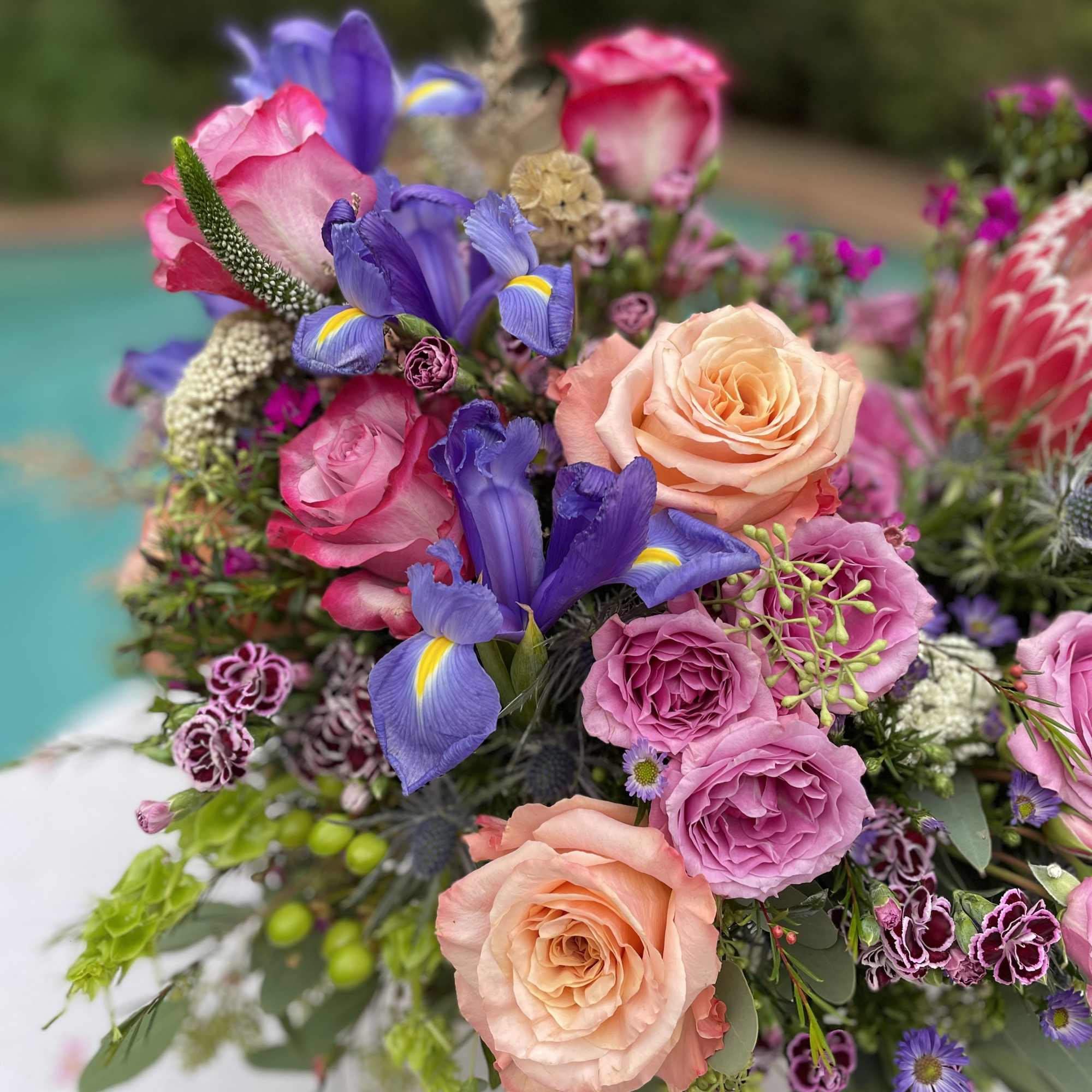 Bouquet of pink and peach roses with purple irises