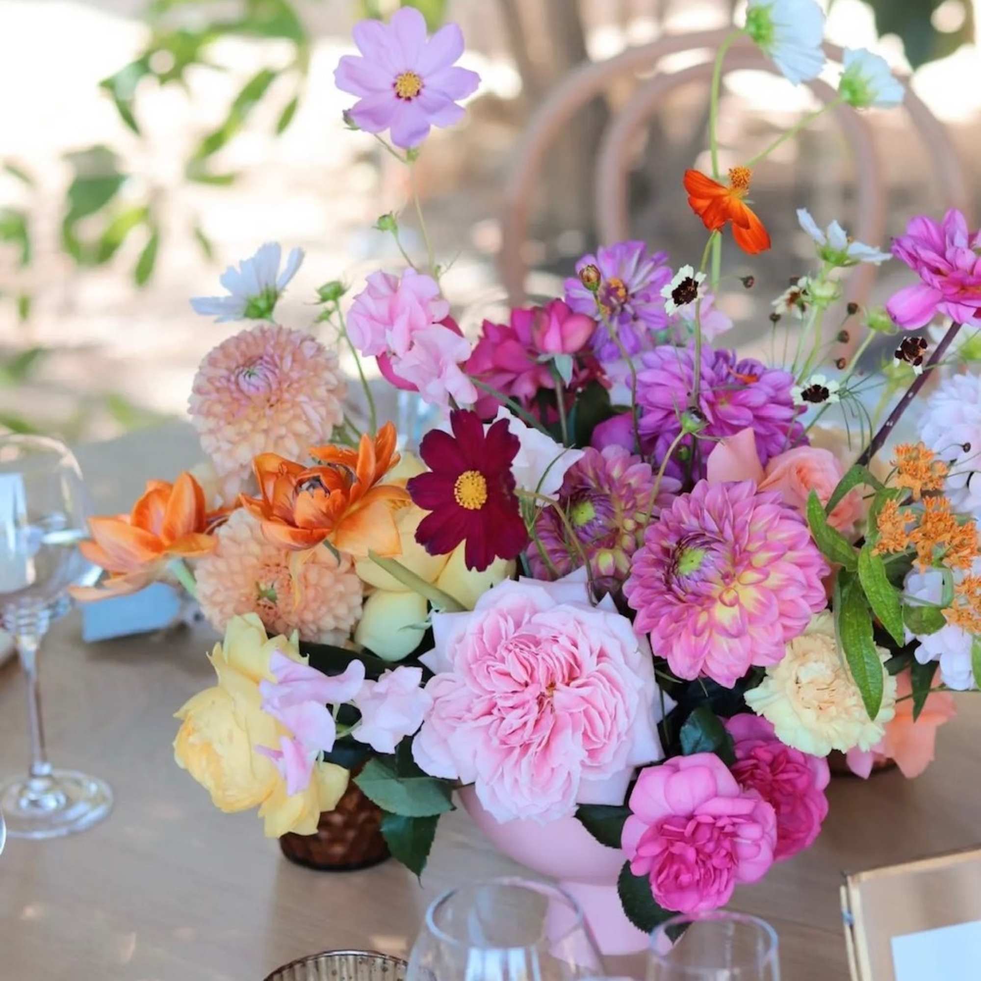 Colorful mixed flower arrangement in a low vase on a table