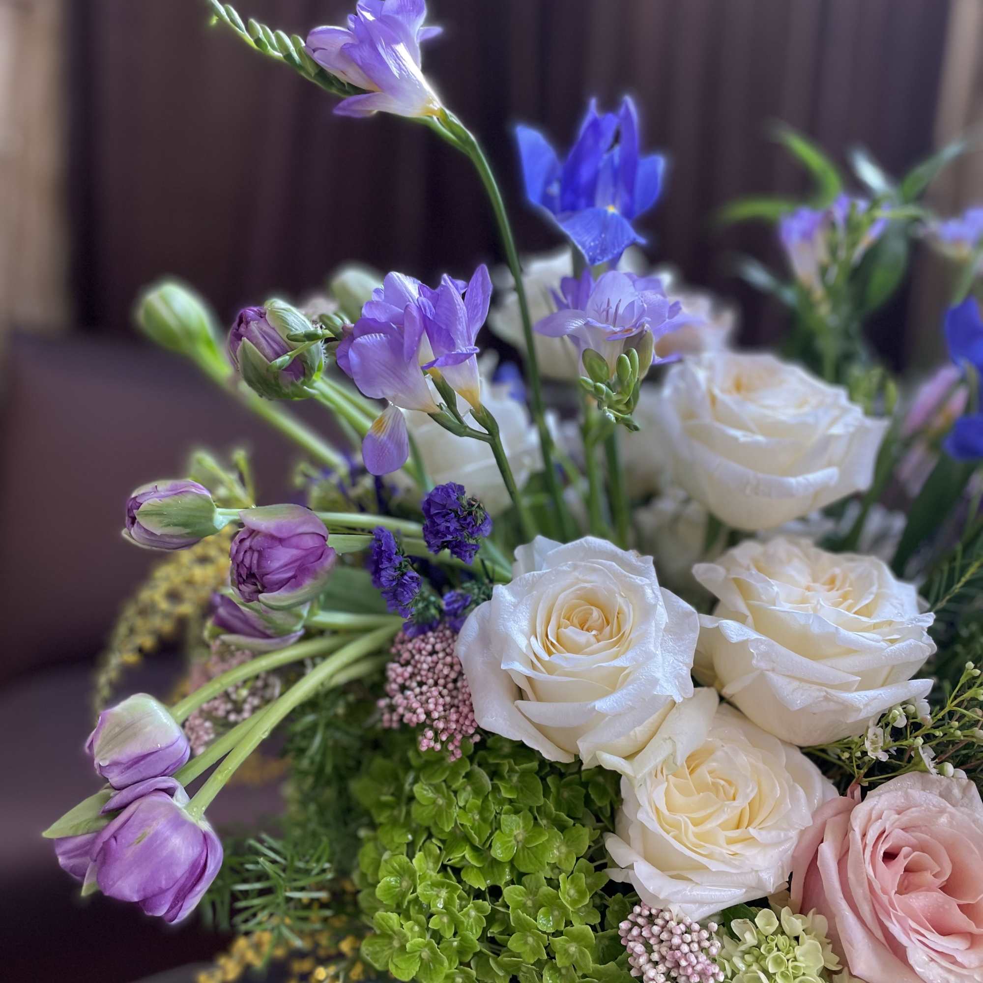Bouquet of white and pink roses with purple blooms