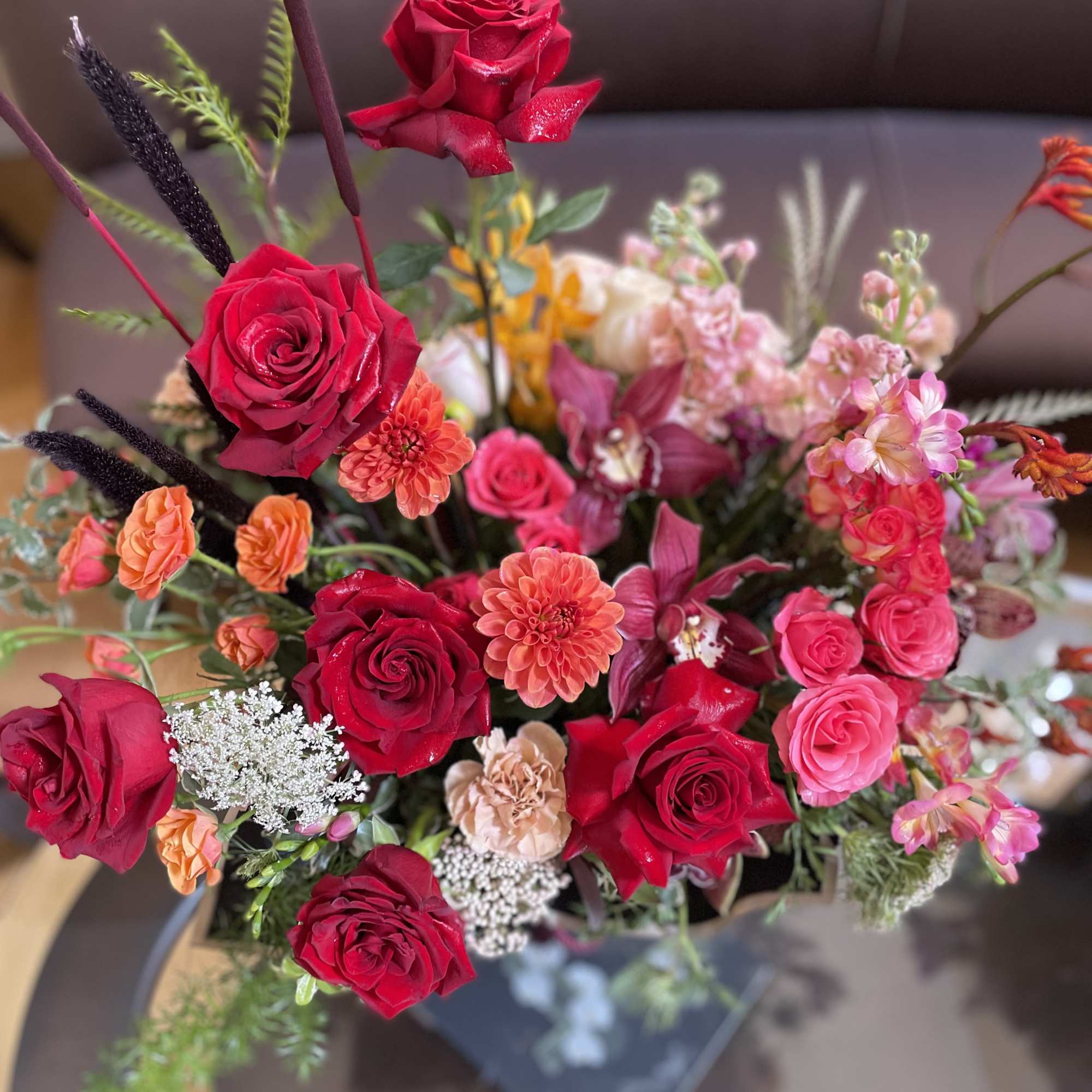 Bouquet of red and pink roses with orange accent flowers