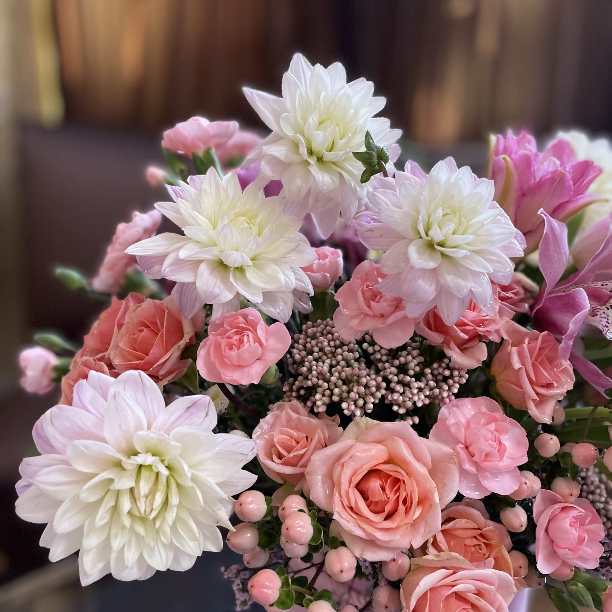 Pink and white bouquet of roses and chrysanthemums in a pink vase