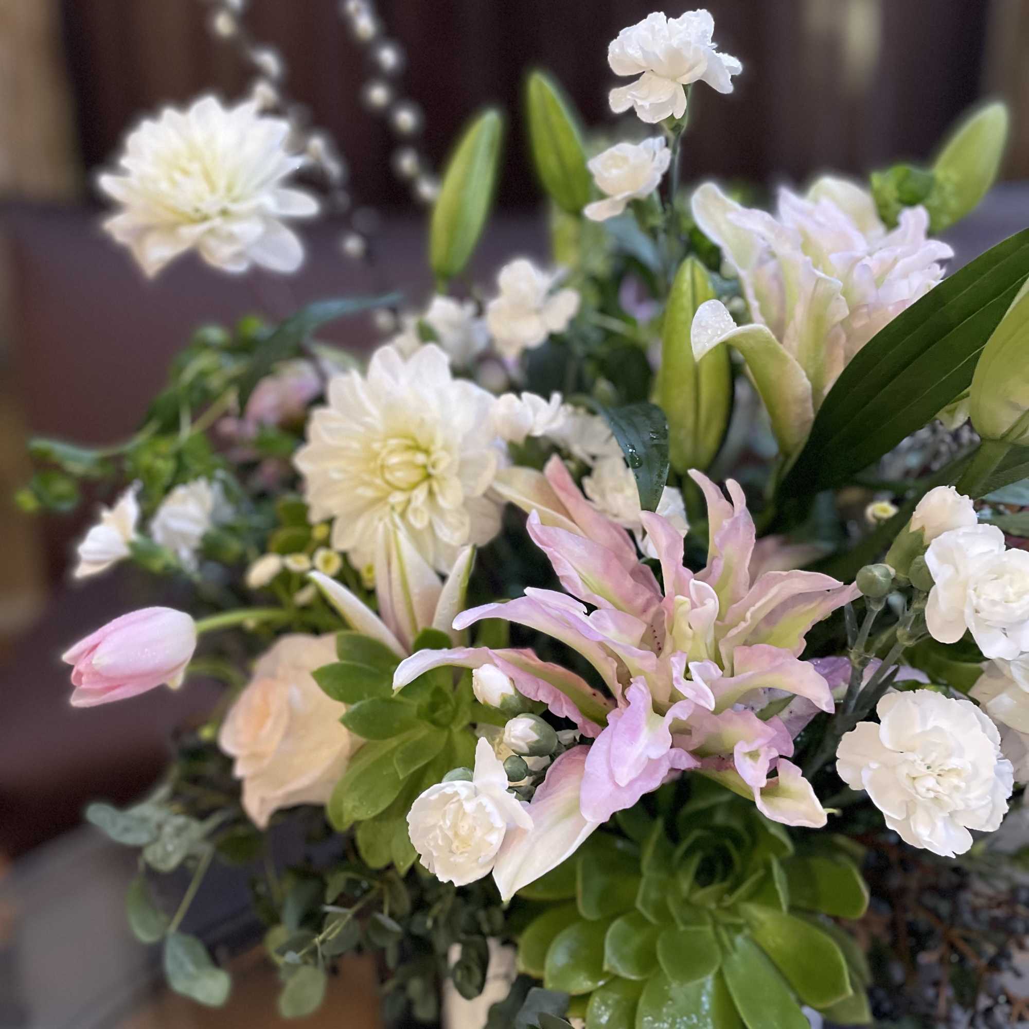 White and pale pink floral arrangement with lilies and chrysanthemums