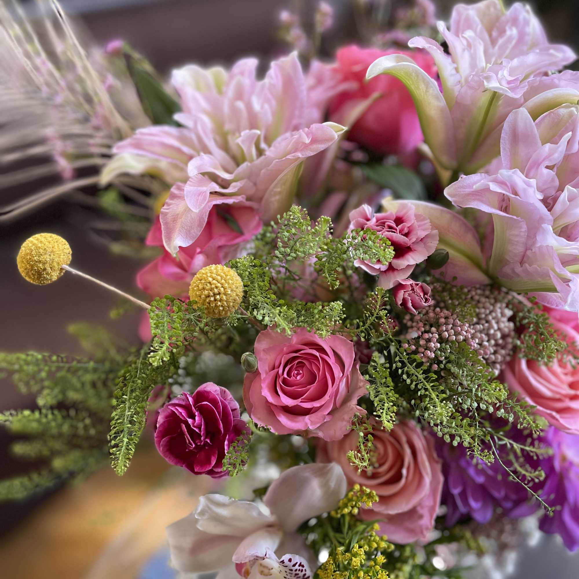 Pink and white mixed bouquet with roses, carnations, and orchids
