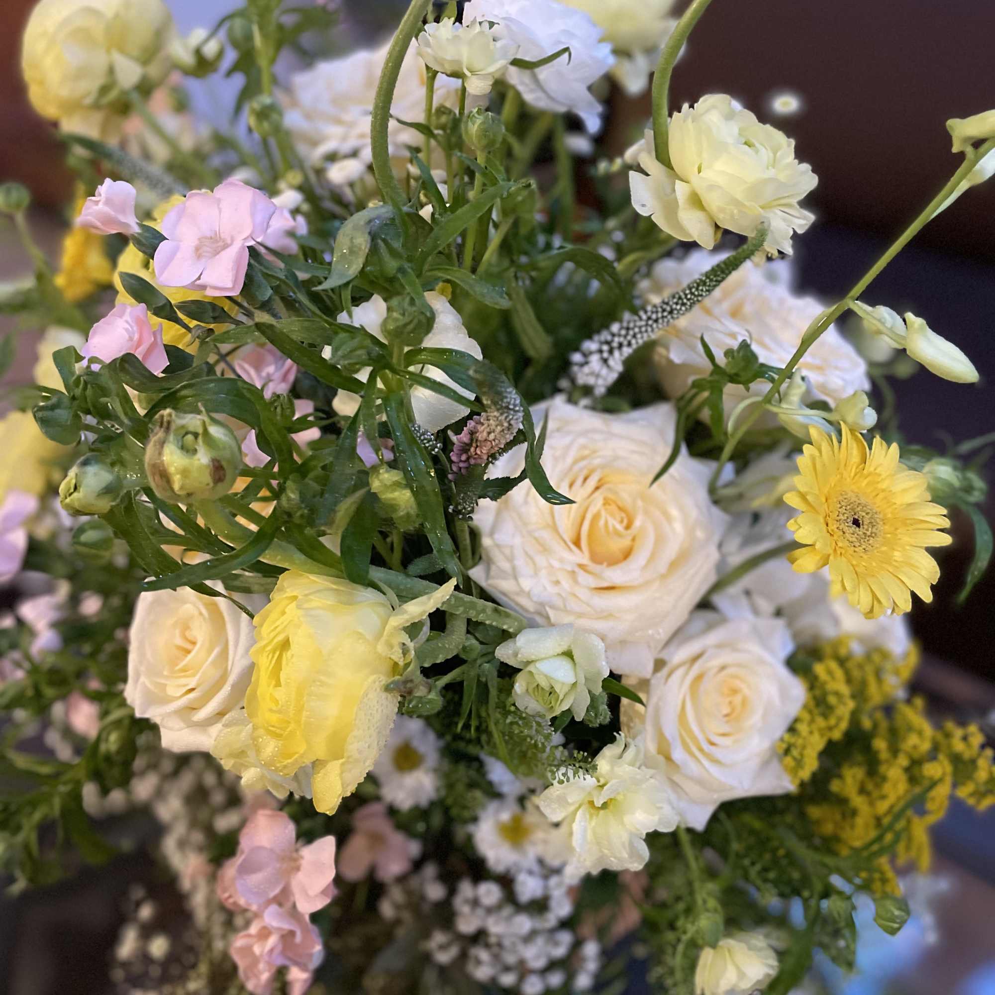 Bouquet of cream roses, yellow gerberas, and pink blooms