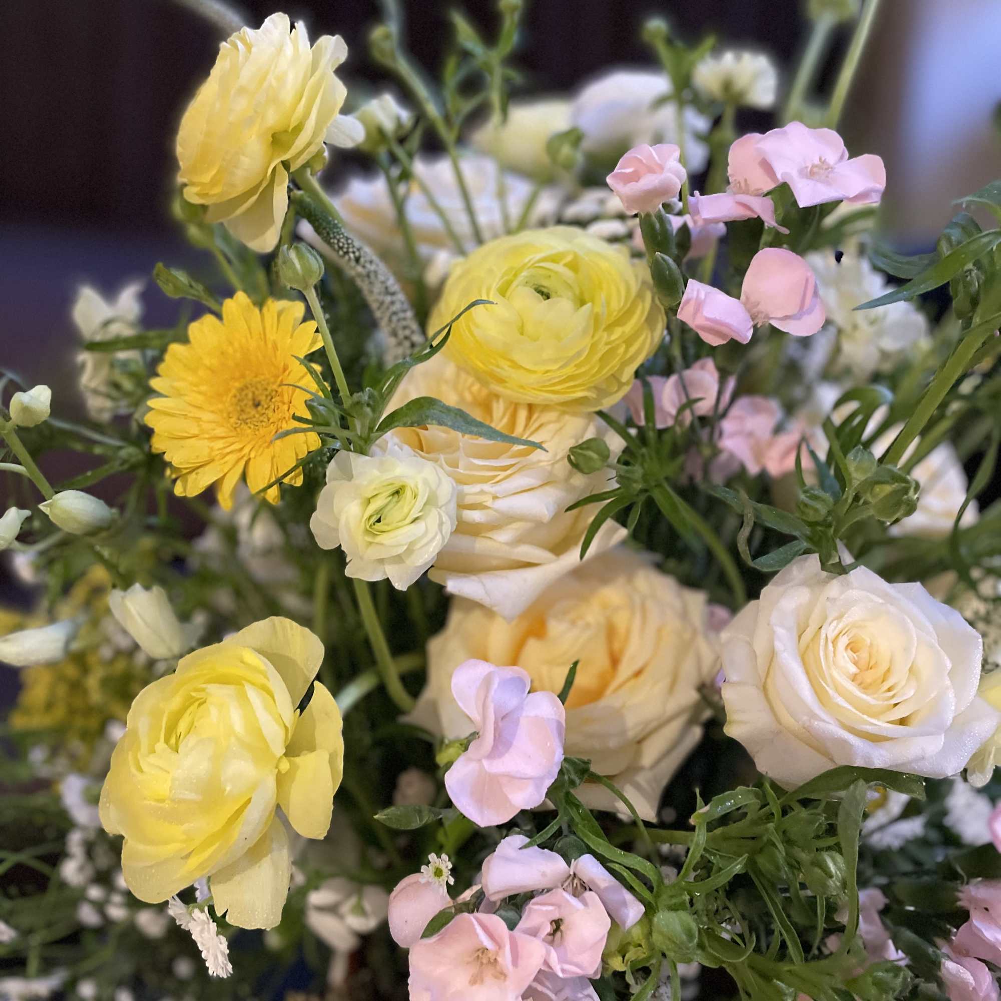 Bouquet of pale yellow and pink flowers with white blooms