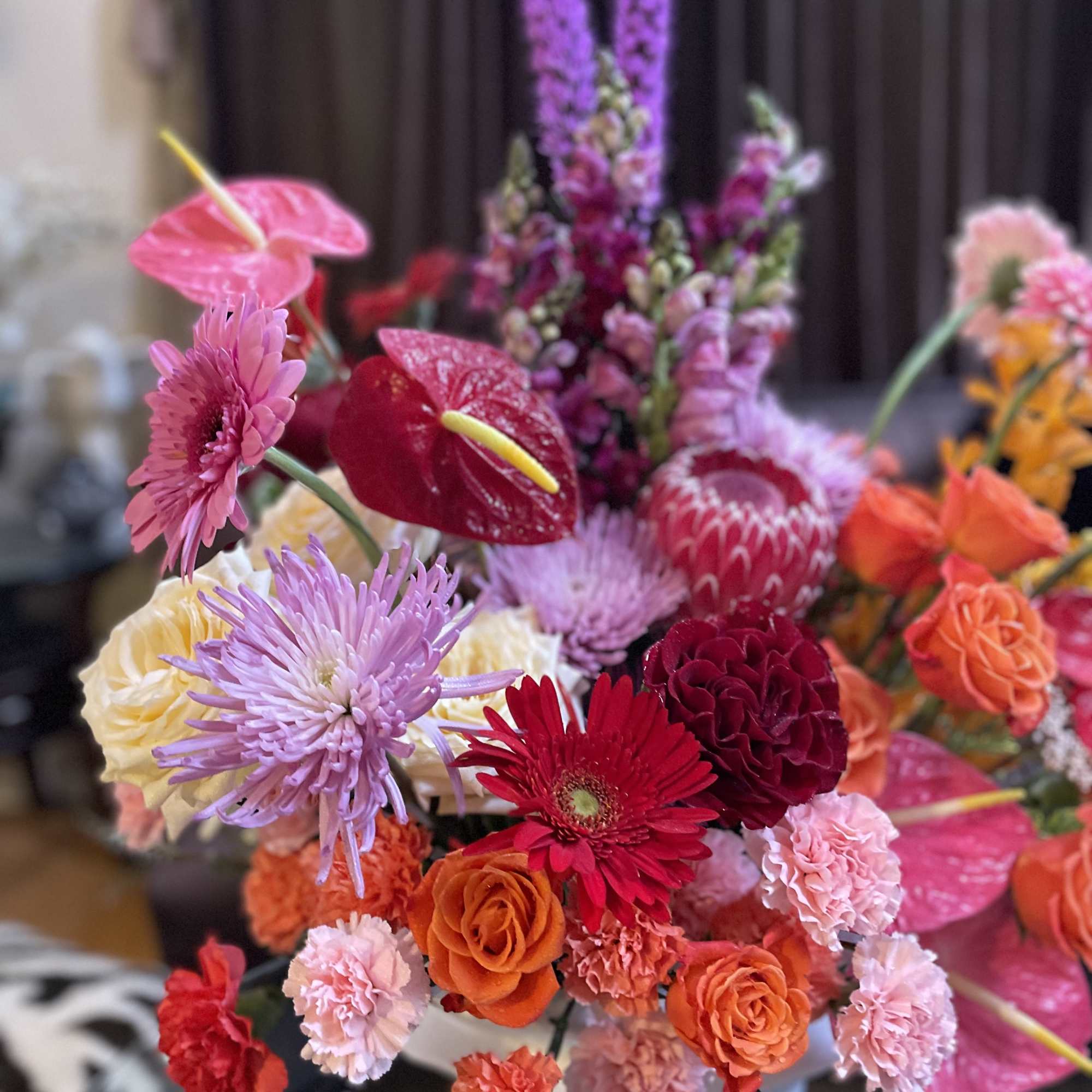 Colorful mixed bouquet with roses, gerbera daisies, and anthuriums