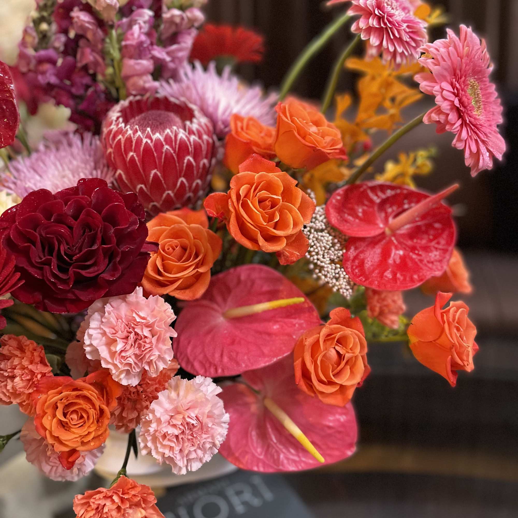 Bright mixed bouquet with roses, anthuriums, and pink gerberas