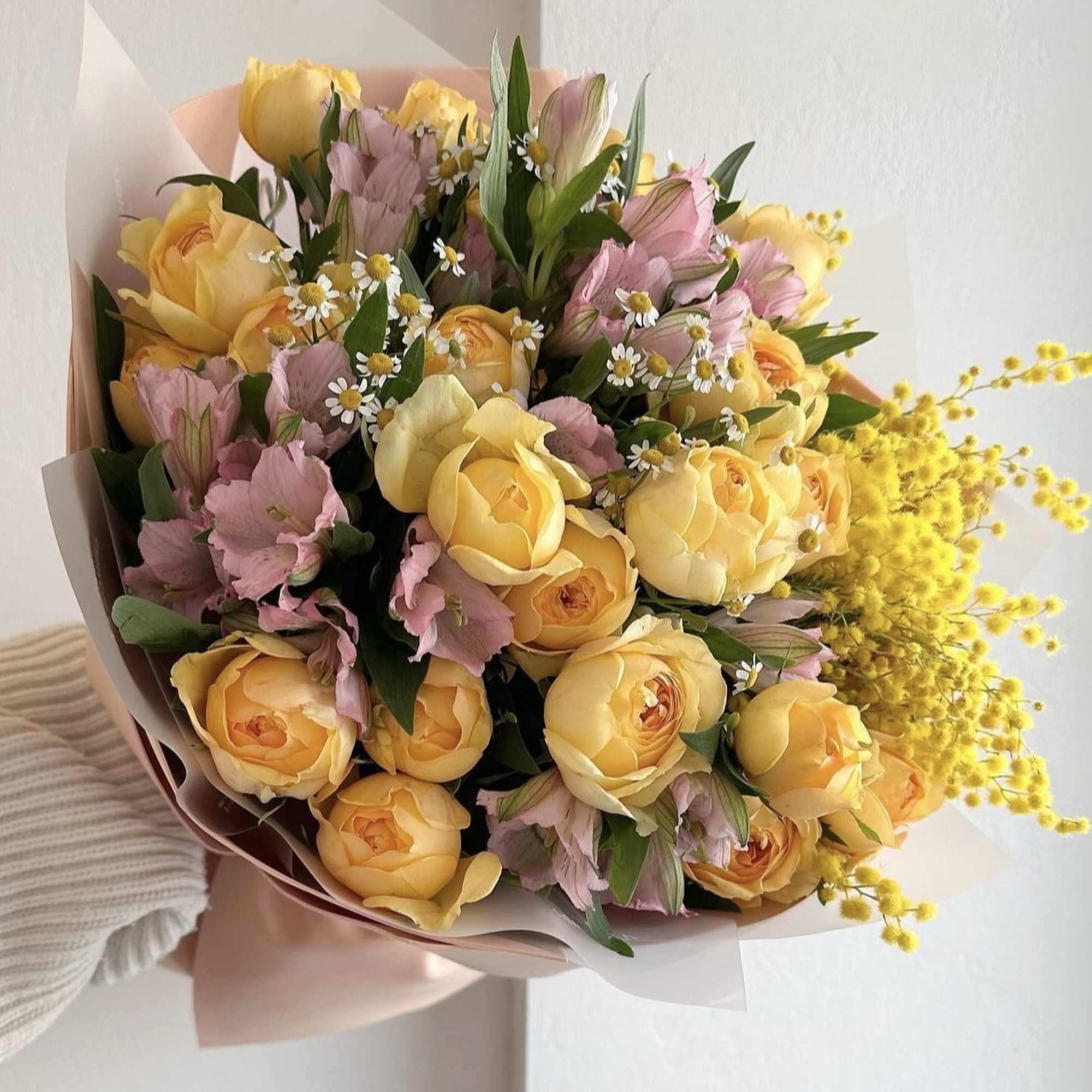 Bouquet of yellow roses and pink alstroemeria with small white daisies