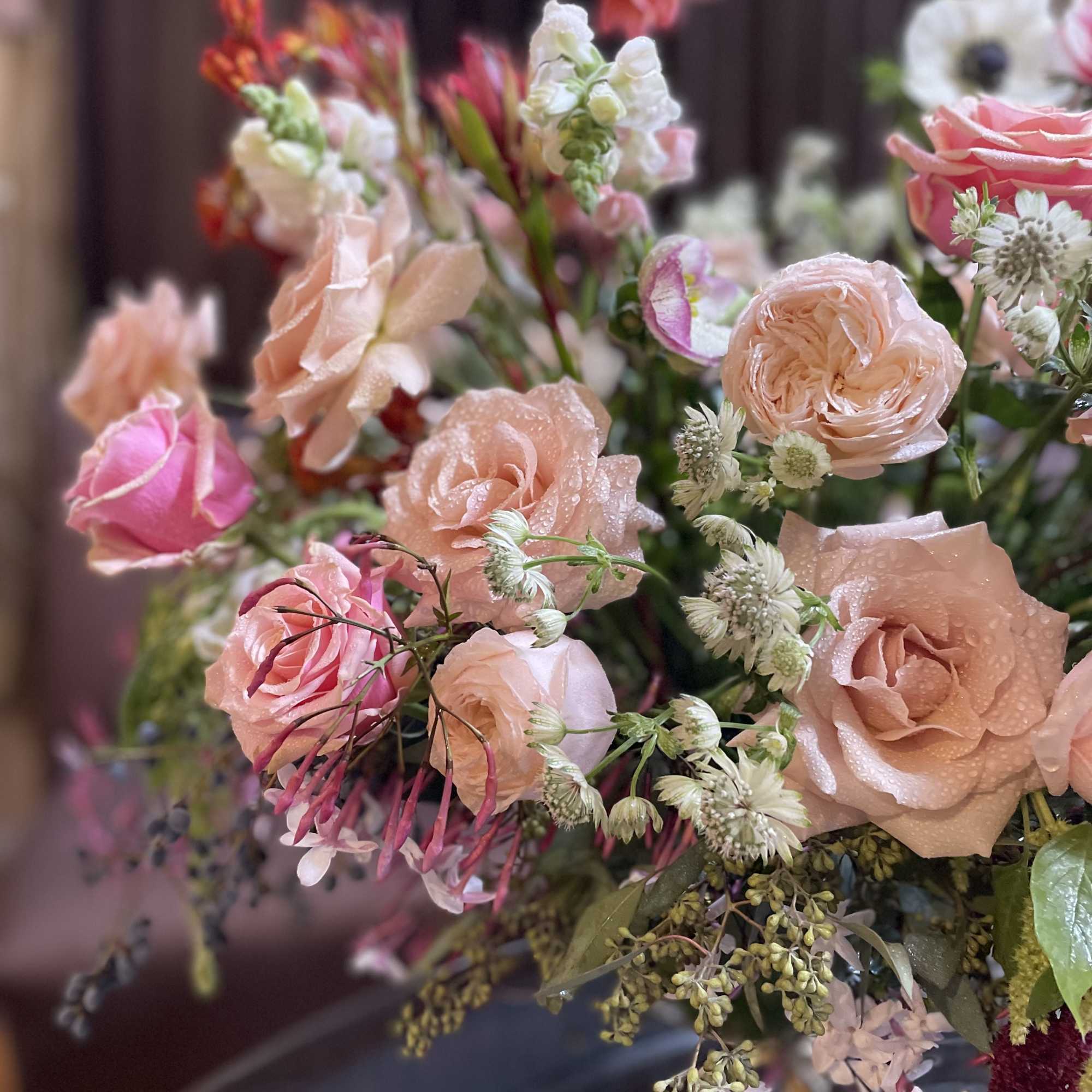 Bouquet of blush and pink roses with small white filler flowers