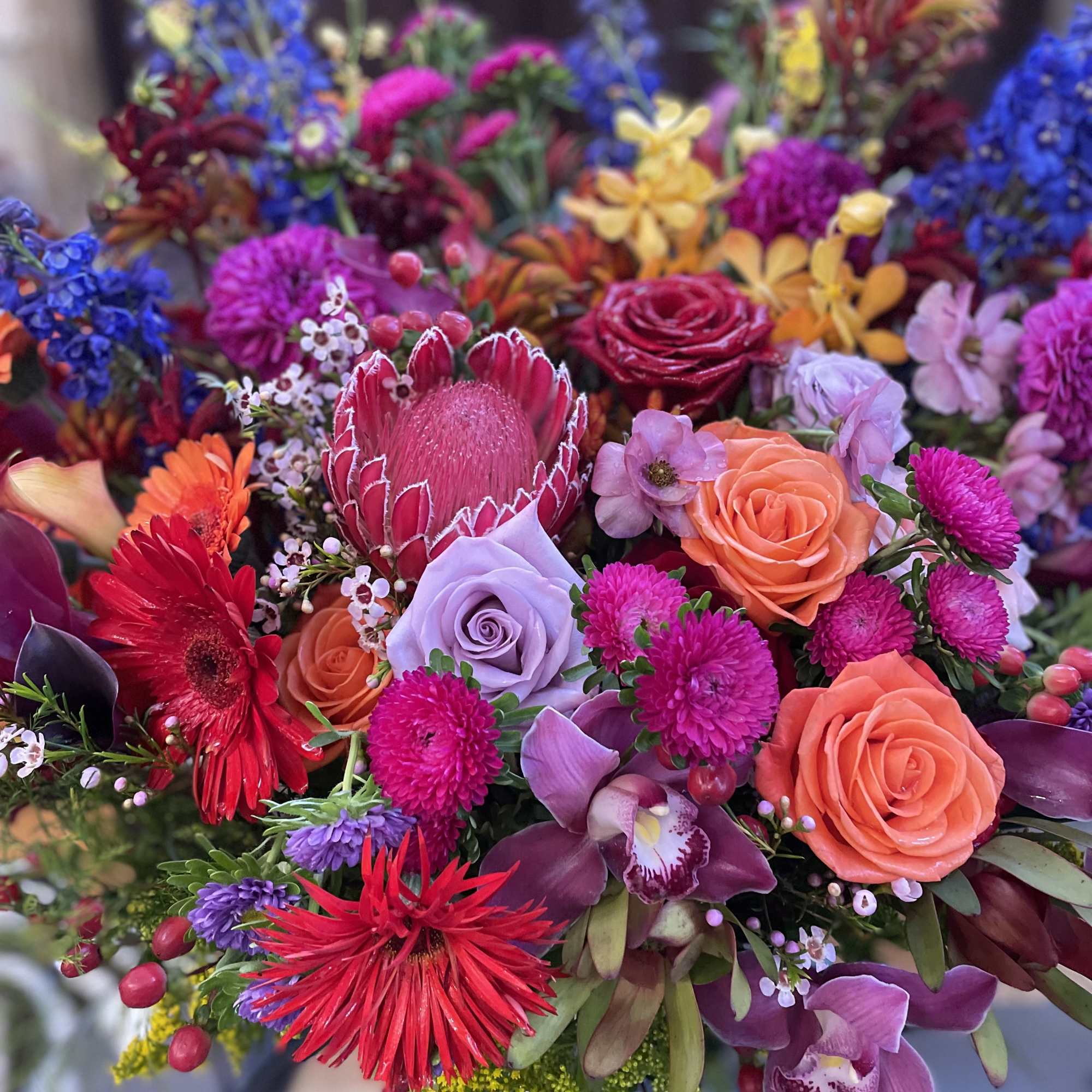 Bright mixed bouquet with roses, orchids, and gerbera daisies
