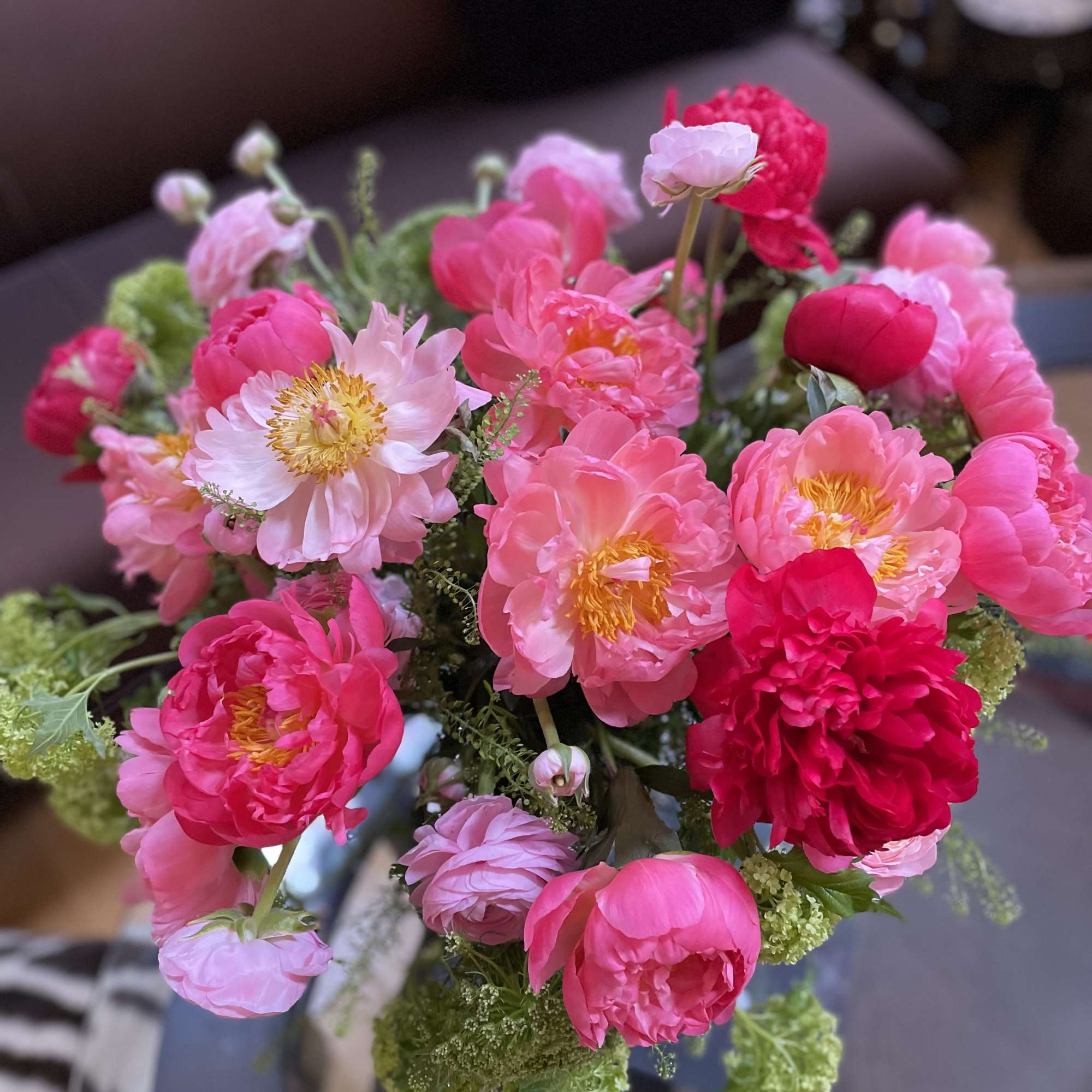 Bouquet of pink peonies and pale pink blooms with green filler