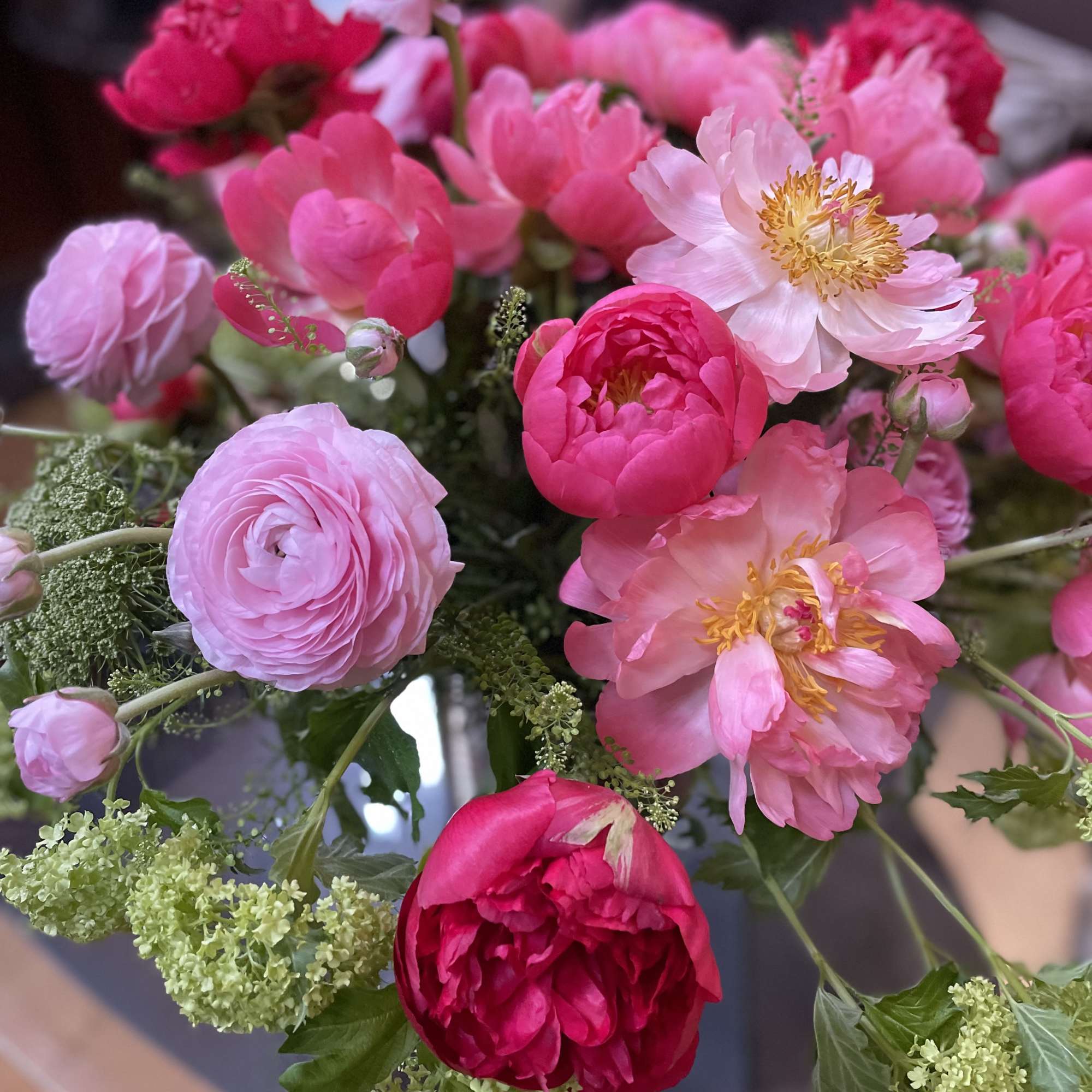 Bouquet of pink and red peonies with pale pink blooms