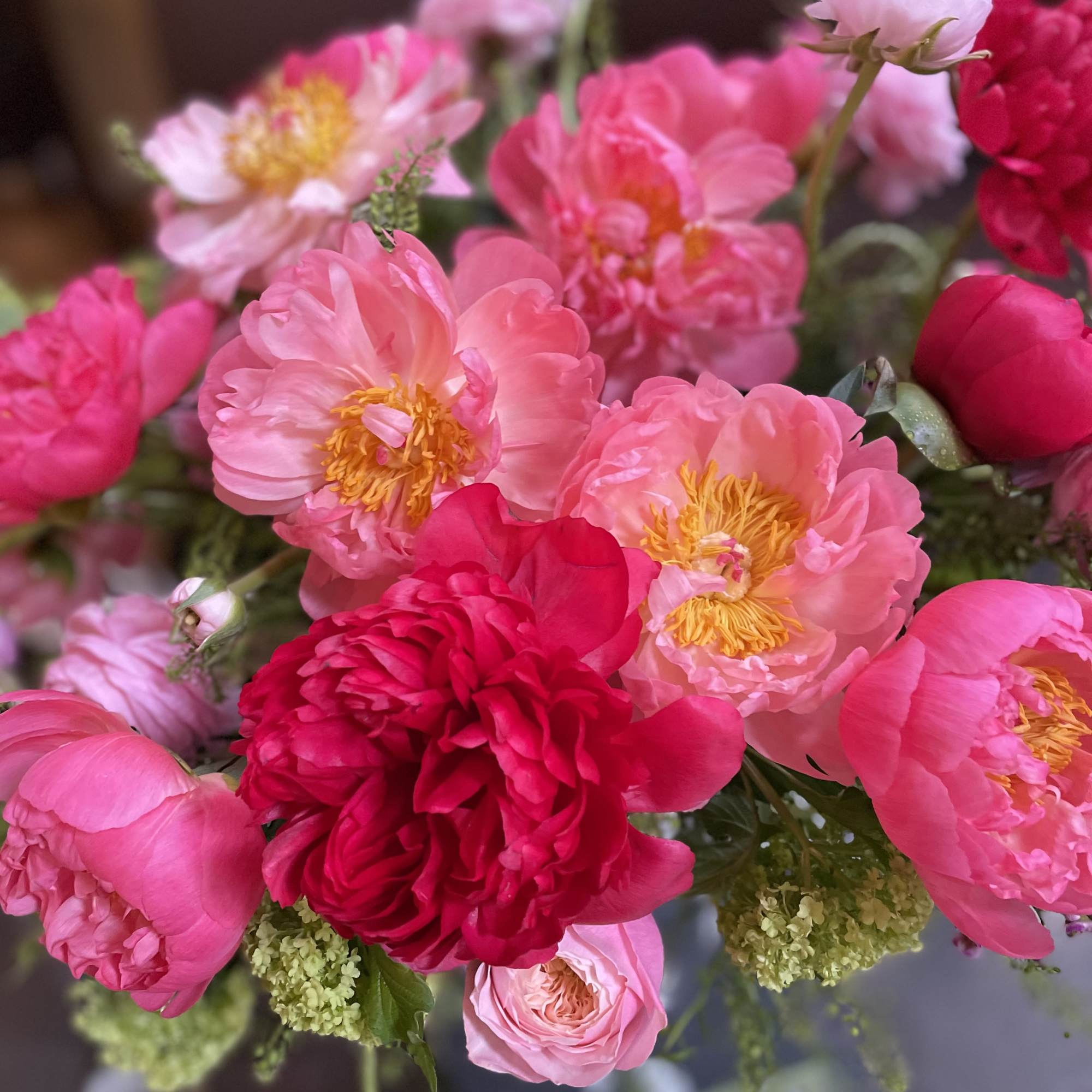 Bouquet of pink peonies and roses with green filler