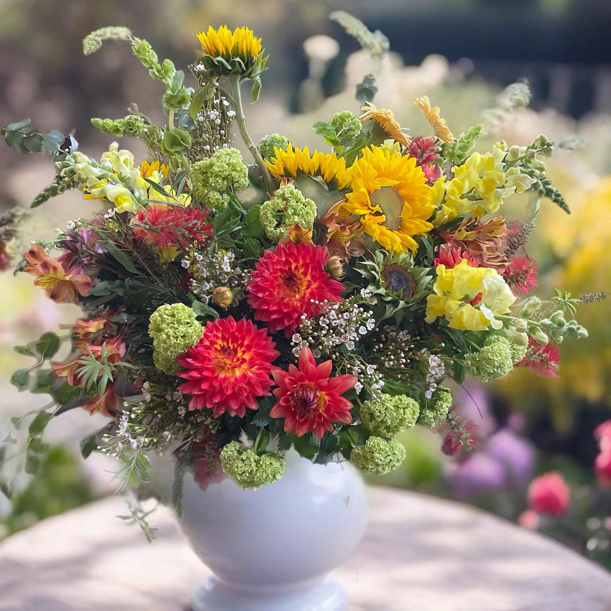 Colorful mixed flower arrangement in a white vase