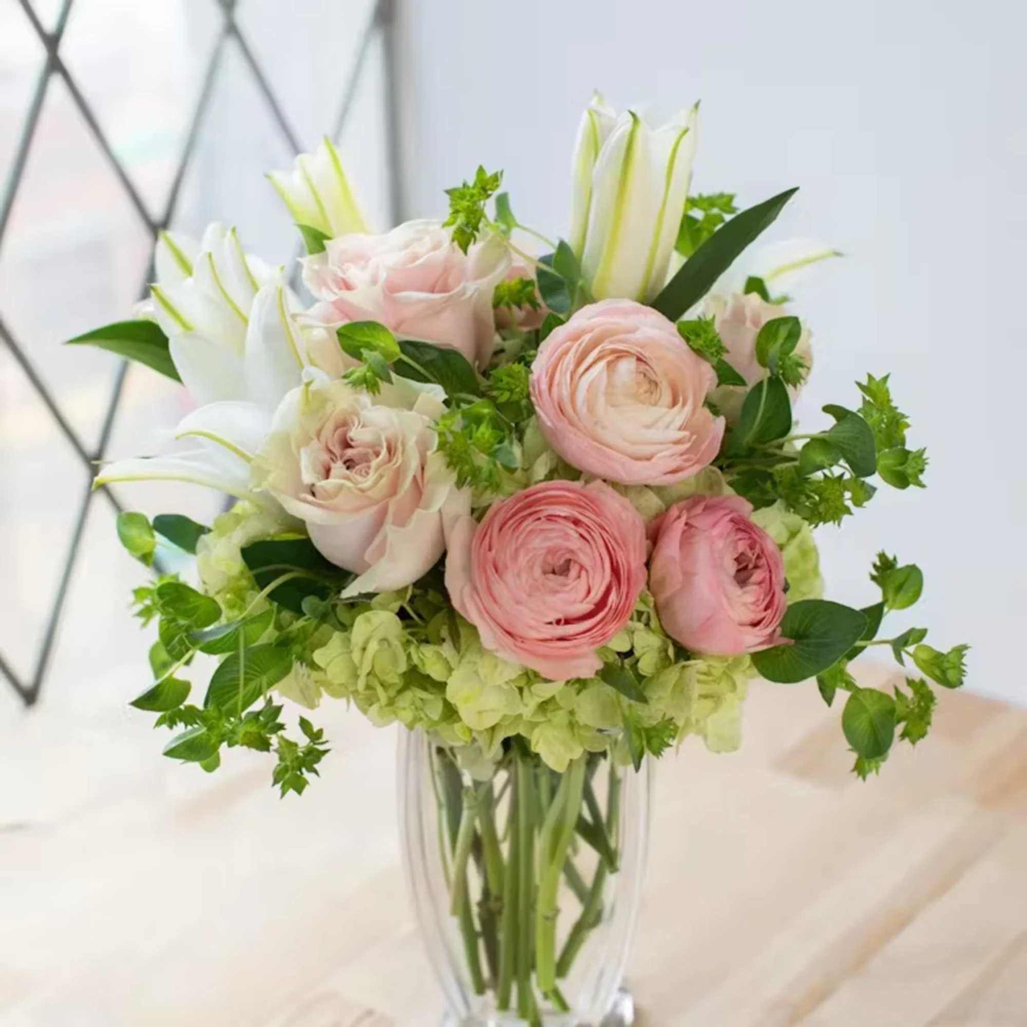 Pink and white bouquet in a clear glass vase