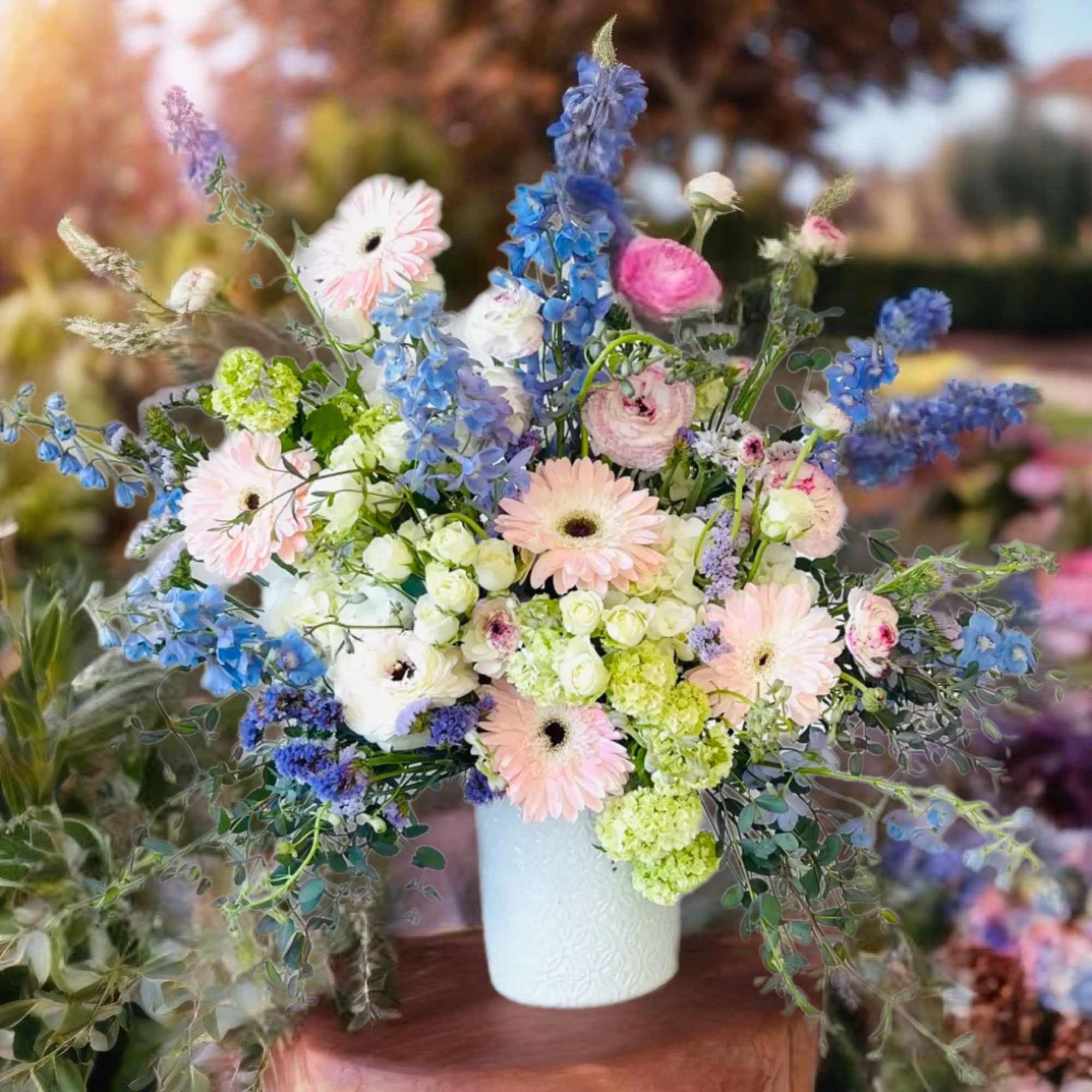 Pastel mixed flower arrangement in a white vase