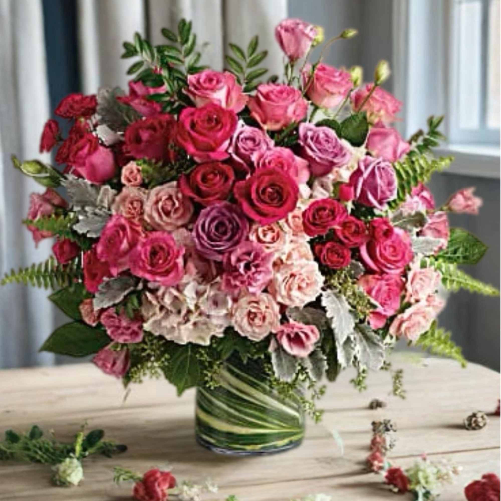 Pink and red rose arrangement in a glass vase