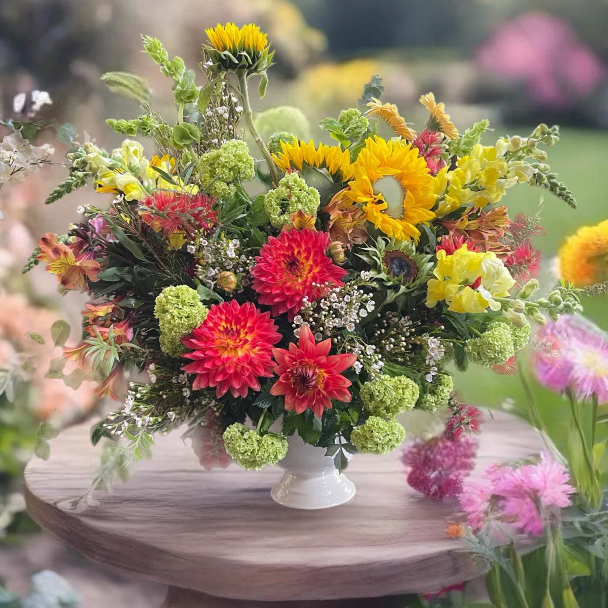 Colorful mixed bouquet in a white pedestal vase
