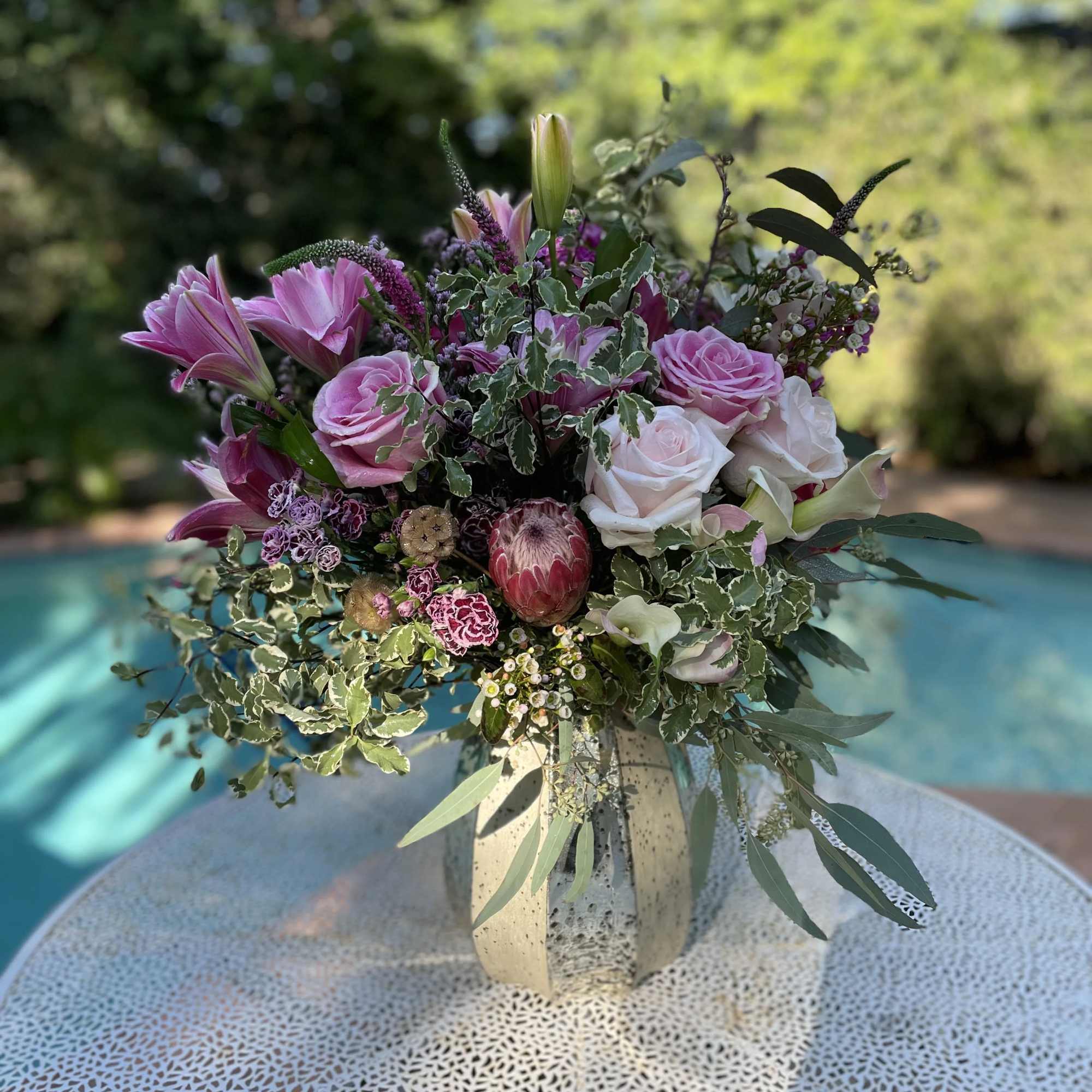 Pink and white floral arrangement in a ceramic vase
