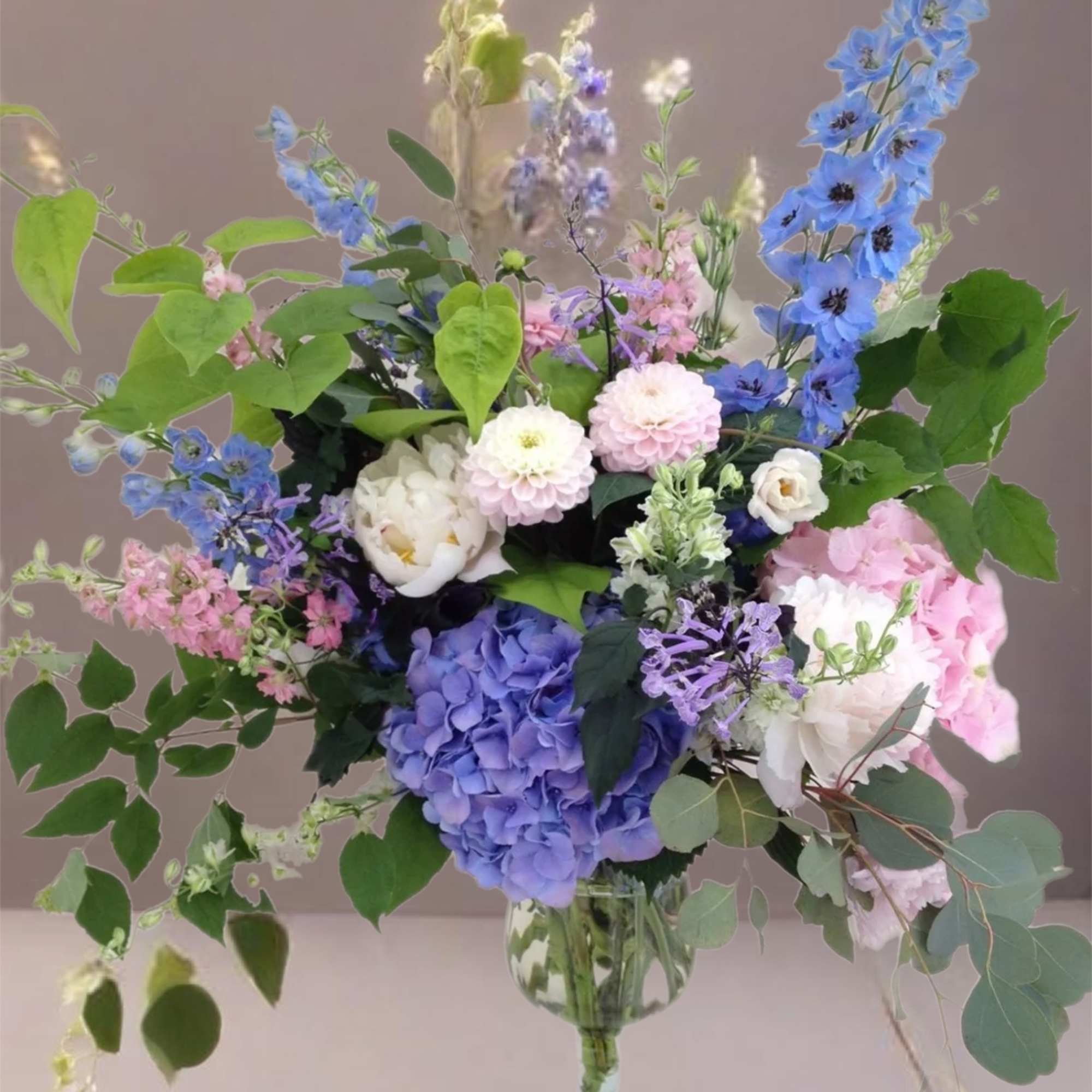 Mixed pastel flower arrangement in a clear glass vase