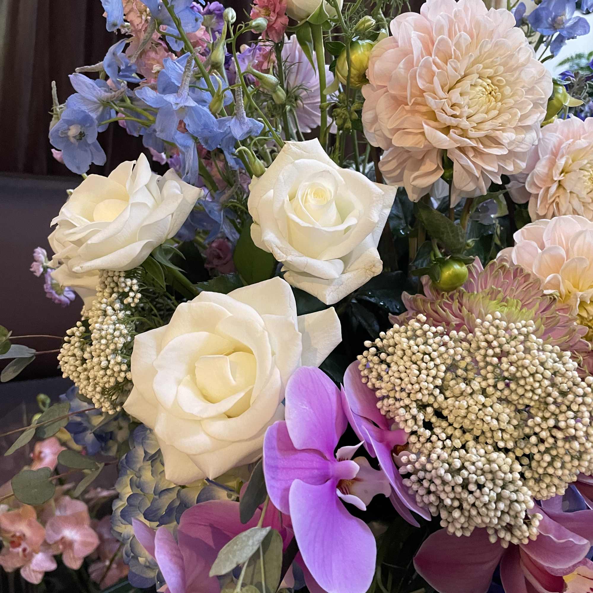 Mixed bouquet with white roses, pink dahlias, and purple orchids