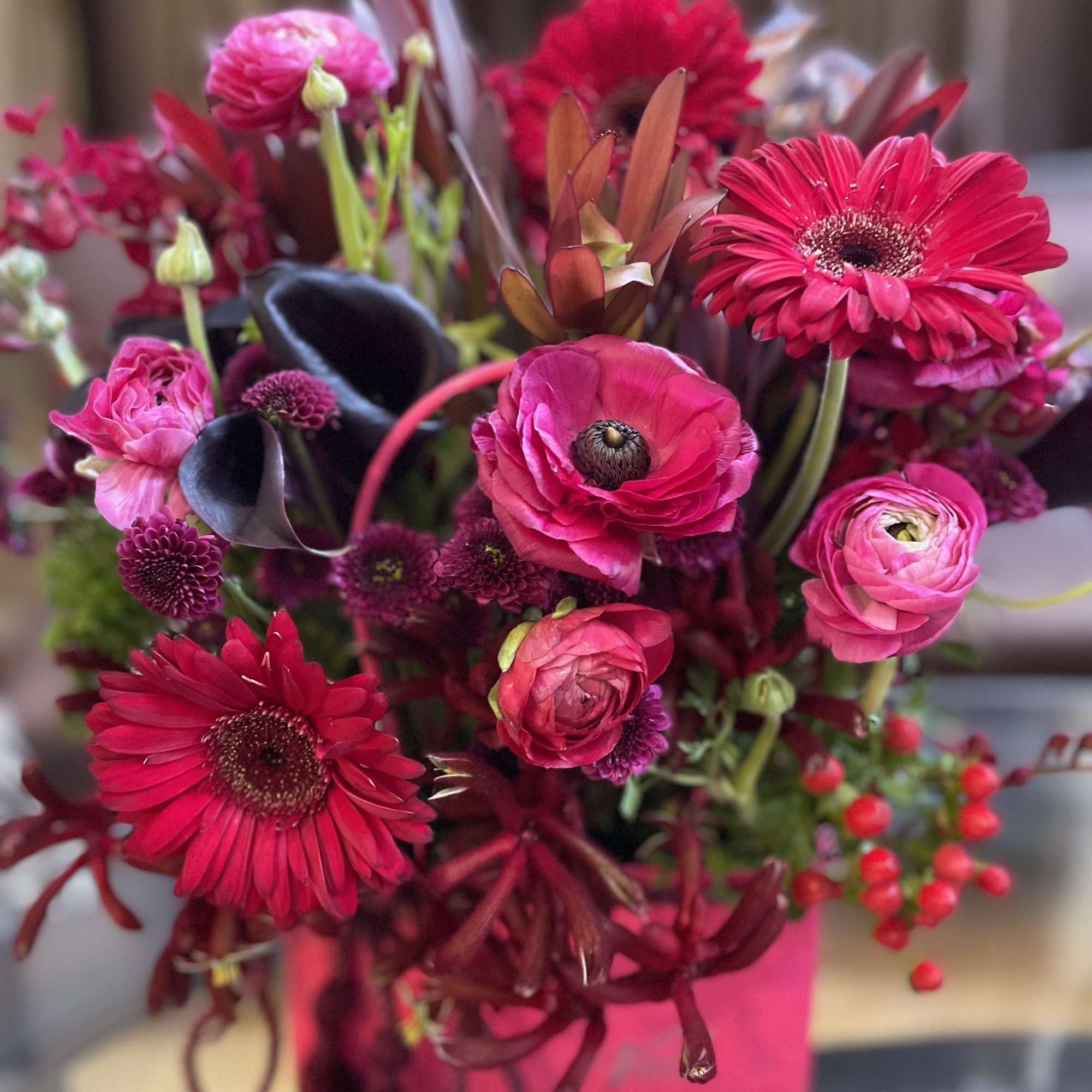Bright pink and red mixed bouquet with gerbera daisies and ranunculus