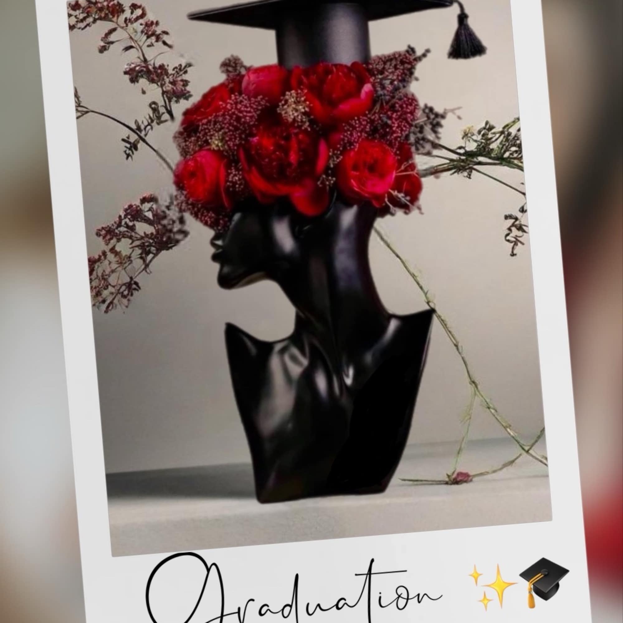 Red rose bouquet arranged with a graduation cap on a black vase