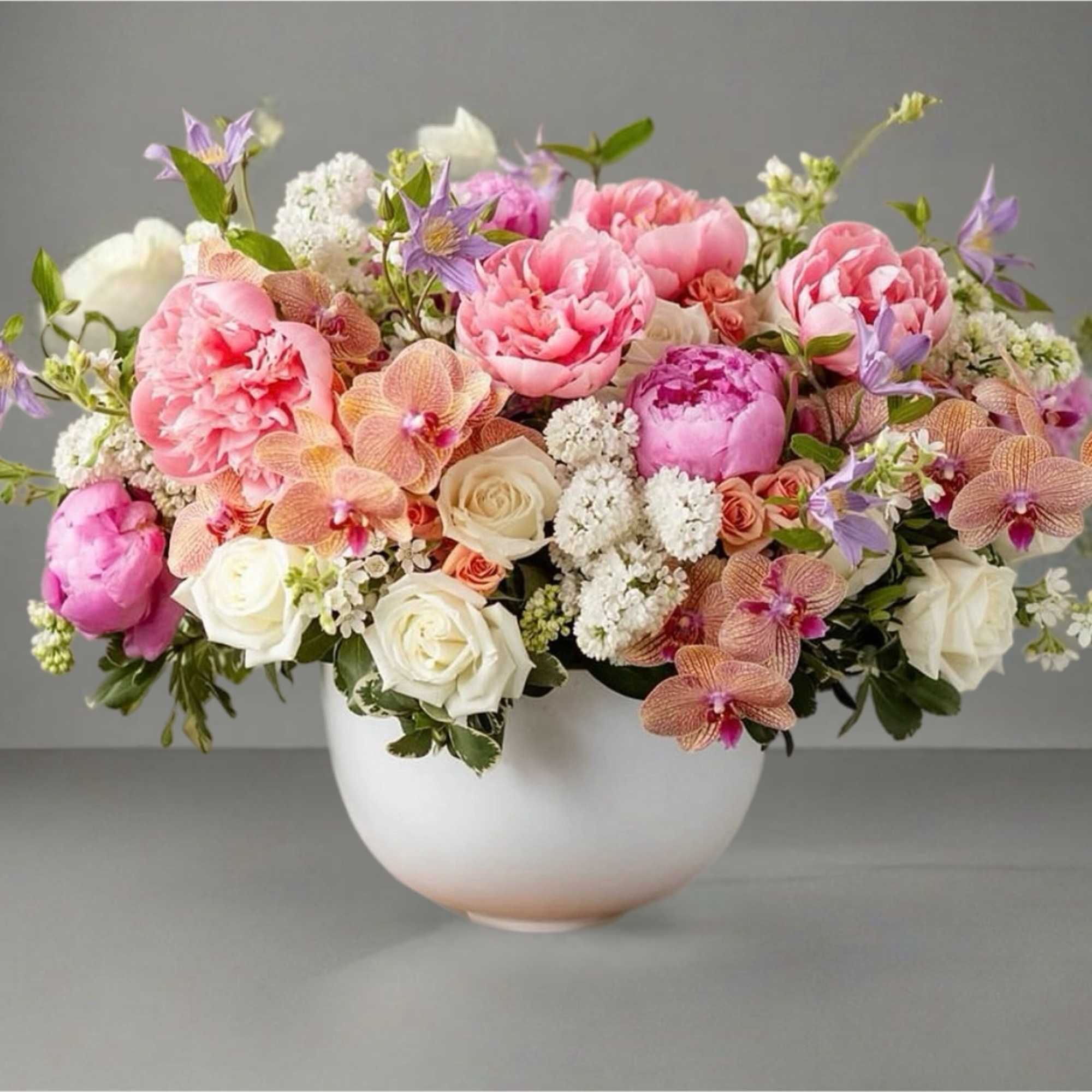 Pink and white floral arrangement in a white bowl vase, photo 2 of 2