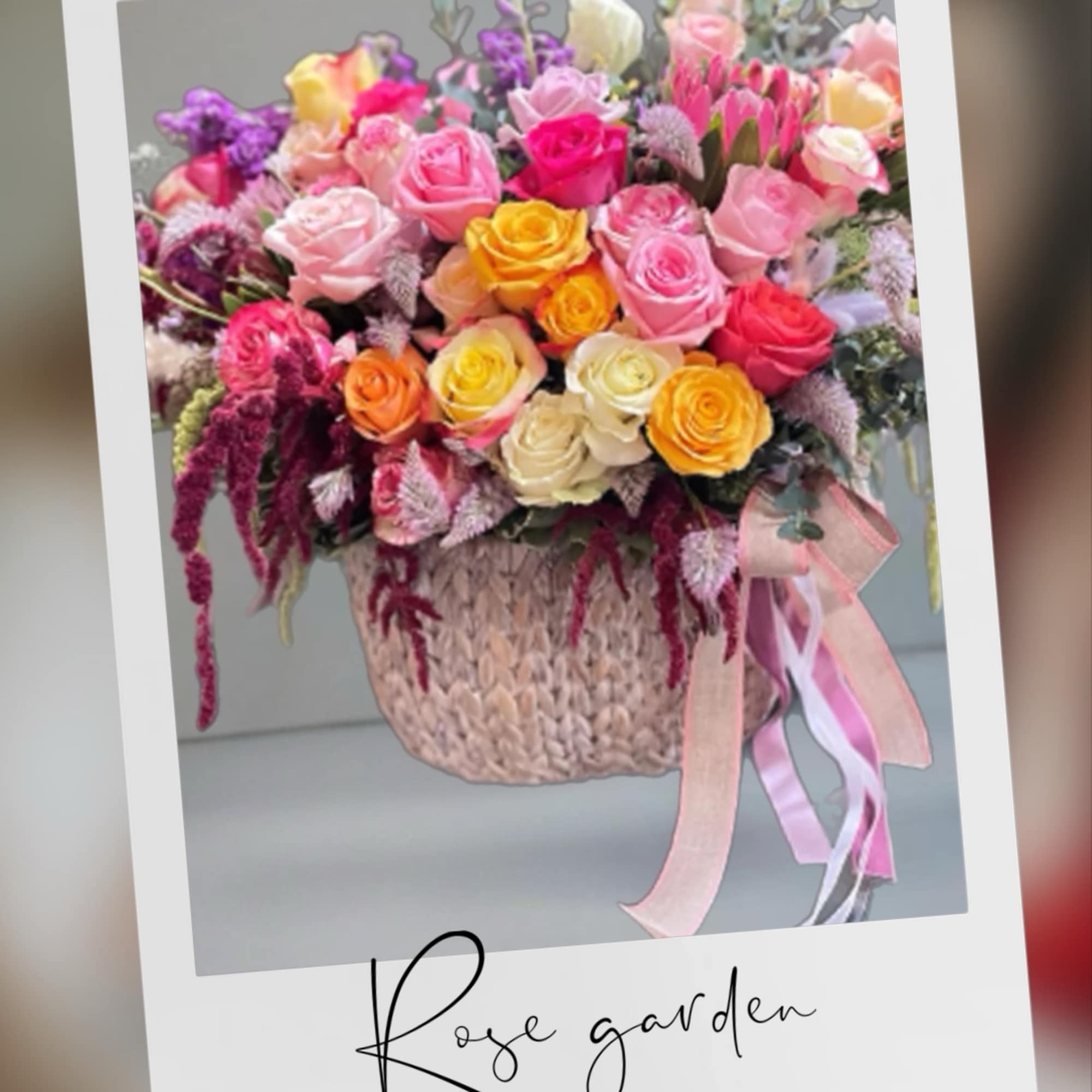 Mixed bouquet of colorful roses in a woven basket with ribbon, photo 3 of 3