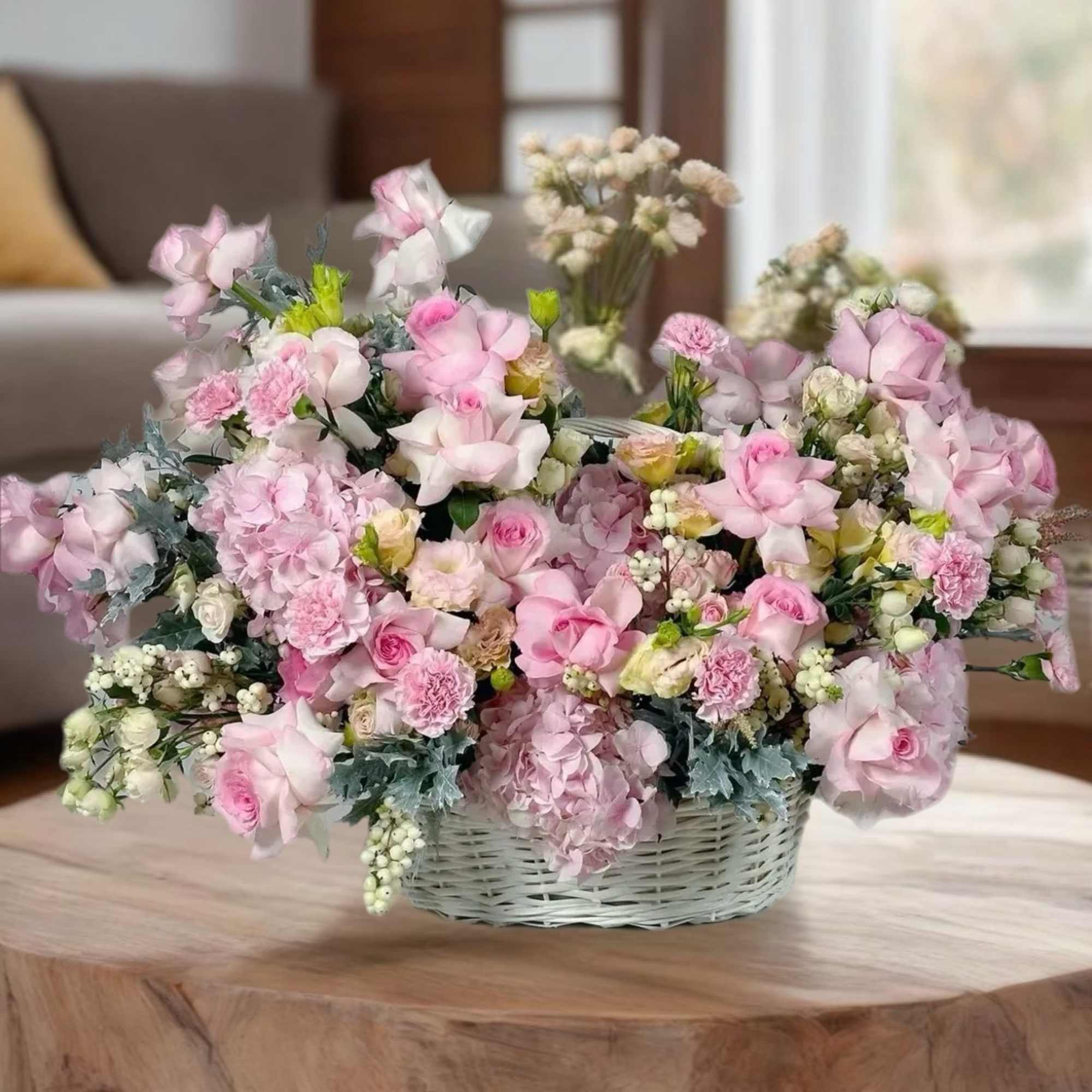 Pink and white flower arrangement in a wicker basket