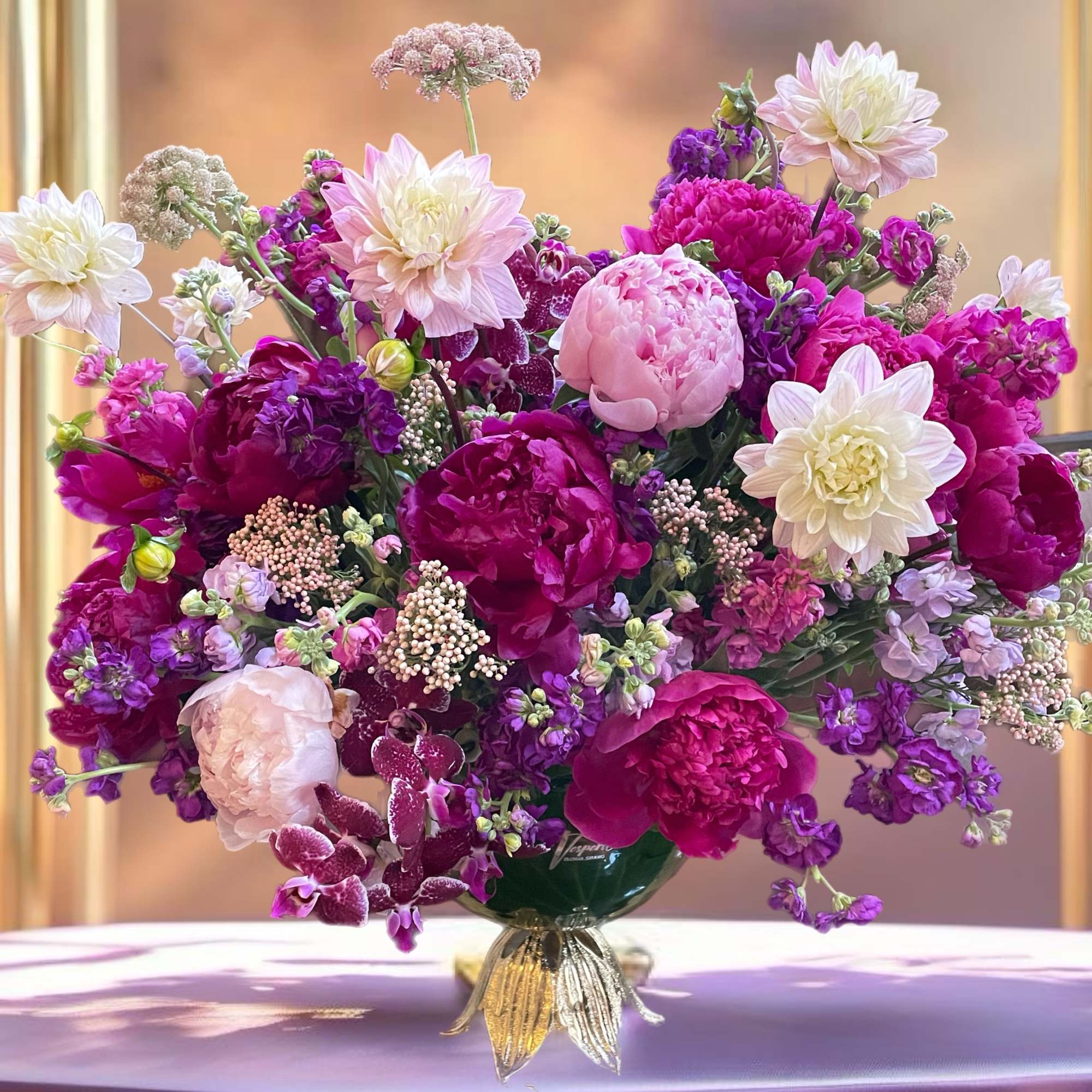 Large pink and purple floral arrangement in a vase