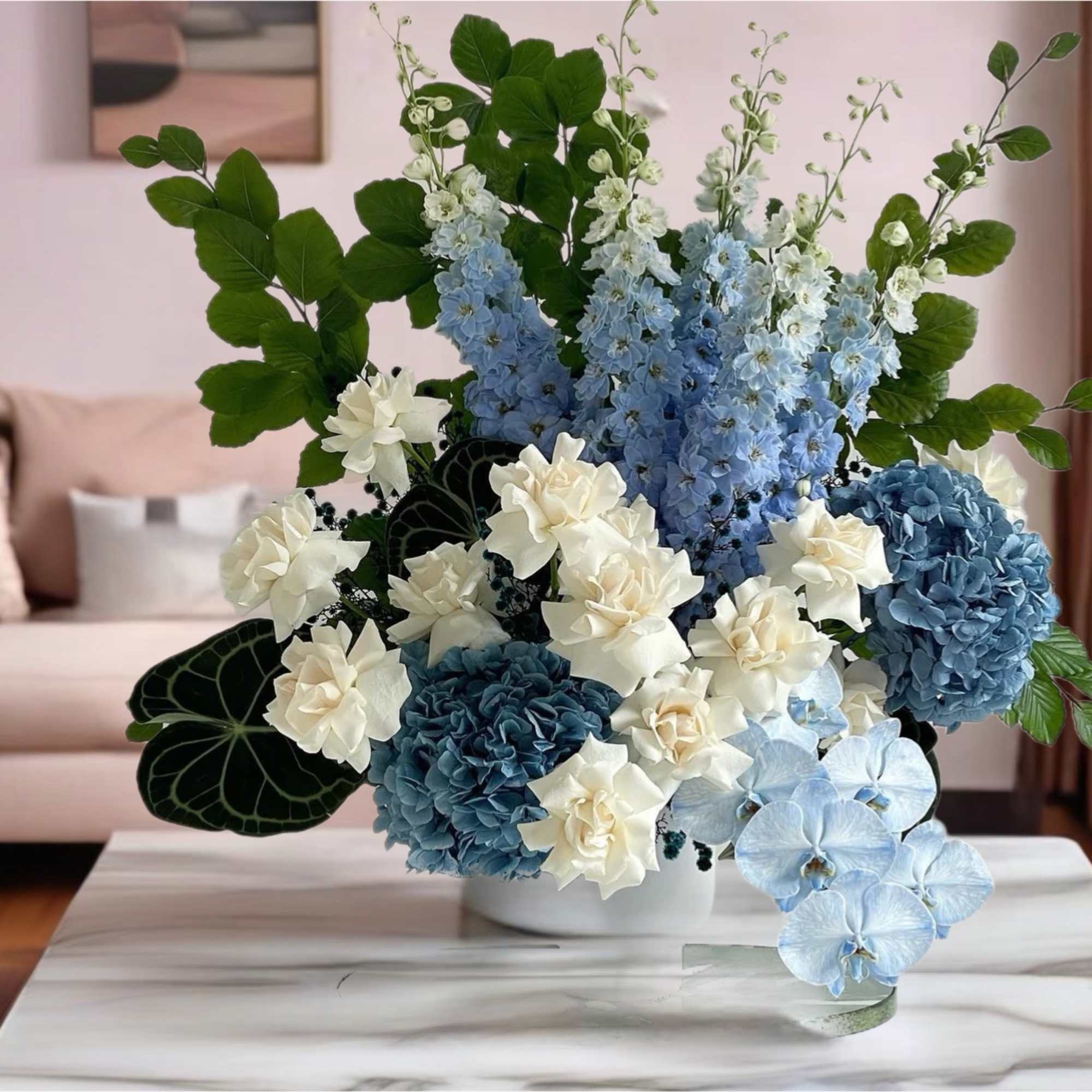Blue and white floral arrangement in a white vase