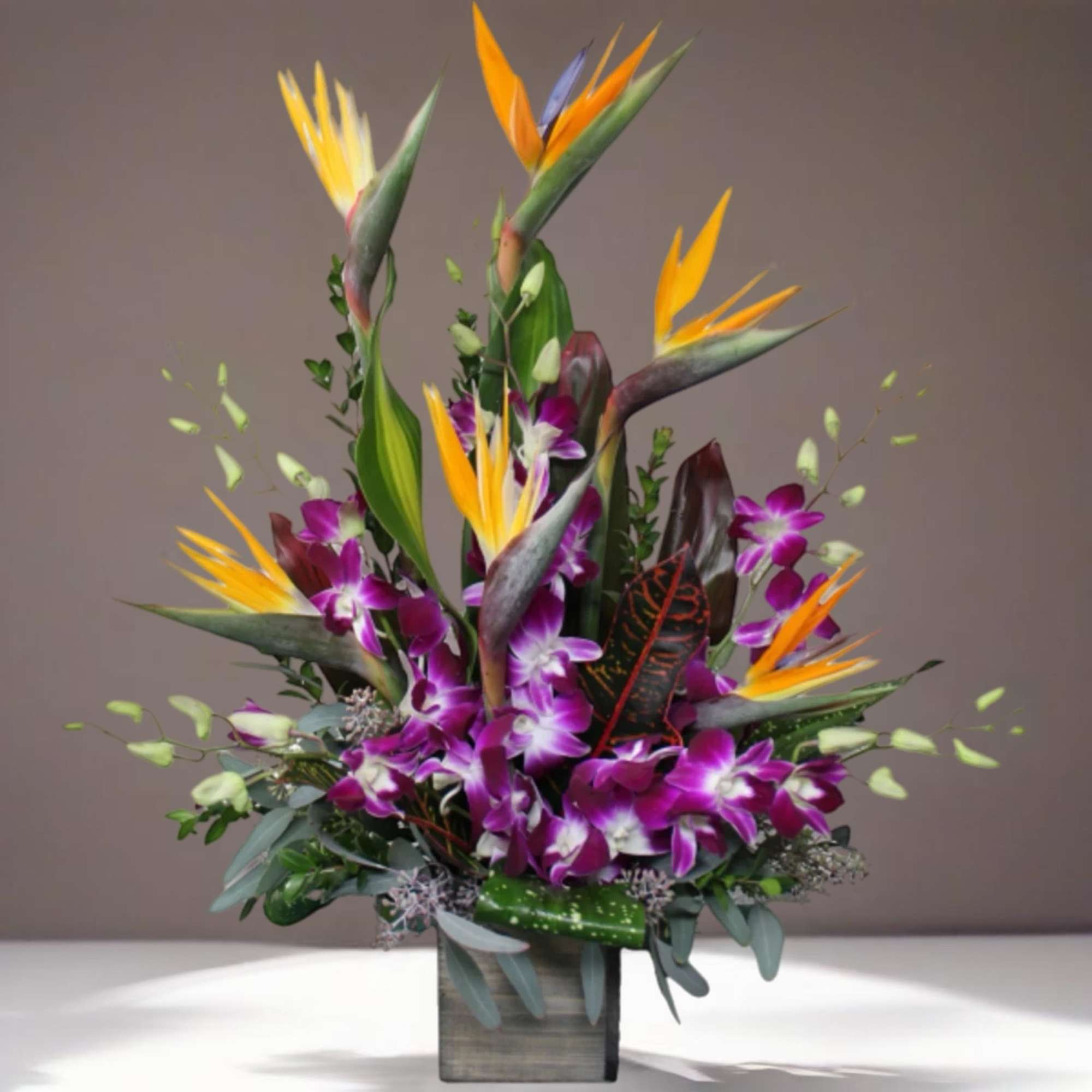Tropical bouquet with purple orchids and bird of paradise in a square vase, photo 3 of 3
