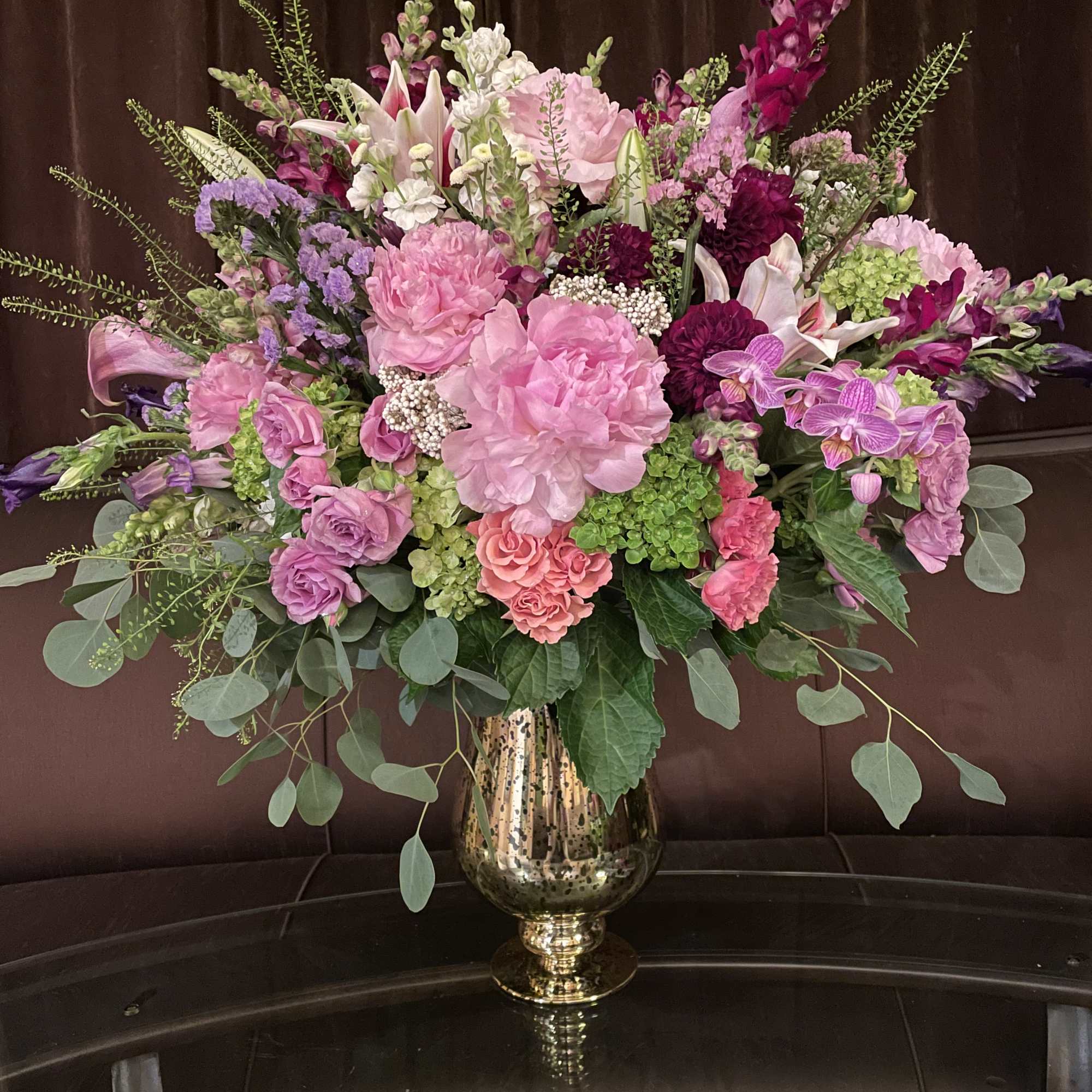 Large pink and purple floral arrangement in a gold vase, photo 2 of 2