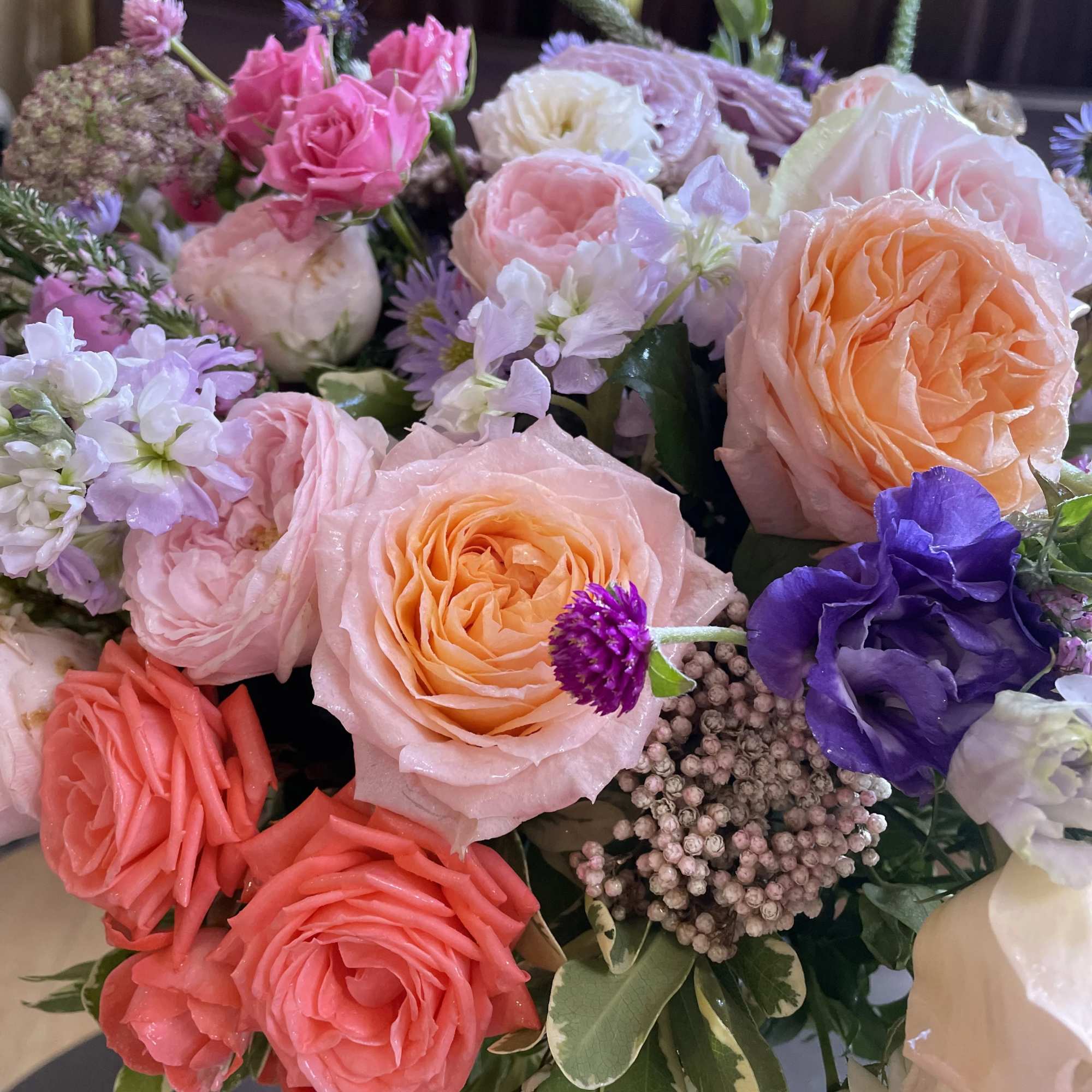 Mixed bouquet of pink, peach, white, and purple flowers