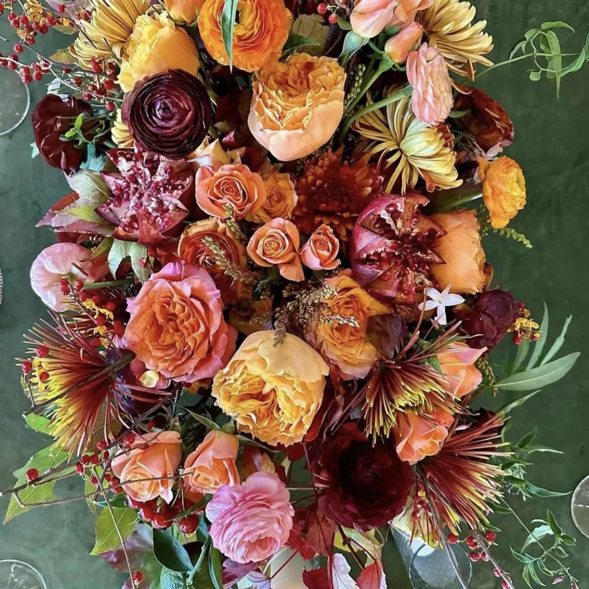 Mixed bouquet of orange, pink, and burgundy flowers